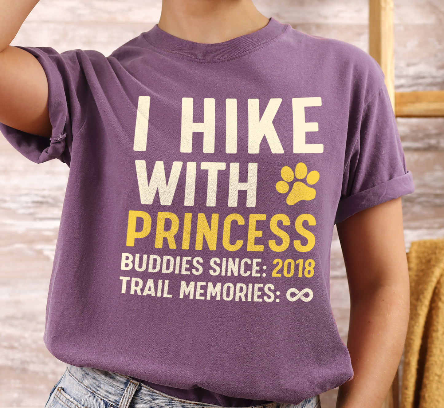 Berry (Dark Violet) graphic t-shirt with 'Trail Buddies Personalized' design featuring 'I Hike with' text and customizable pet name field in cream and yellow lettering with paw prints, plus customizable year for 'buddies since' and trail memories infinity.