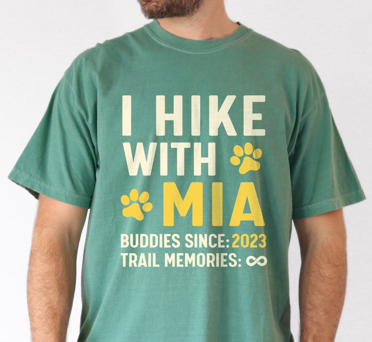 Man wearing Personalized trail buddies shirt for dog hikers with custom pet name of Mia paw print and buddies since year 2023 featuring infinite memories design perfect gift for outdoor enthusiasts and their canine hiking partners