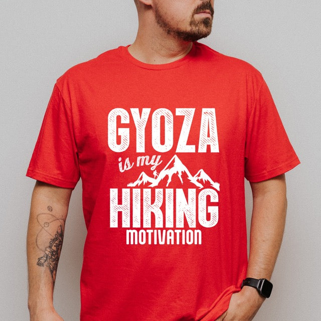 Man wearing red Gyoza is my Hiking Motivation statement t-shirt with bold distressed typography, mountain peaks, and hiker silhouette for gyoza lovers and outdoor enthusiasts on Gildan 64000 Softstyle 100% cotton