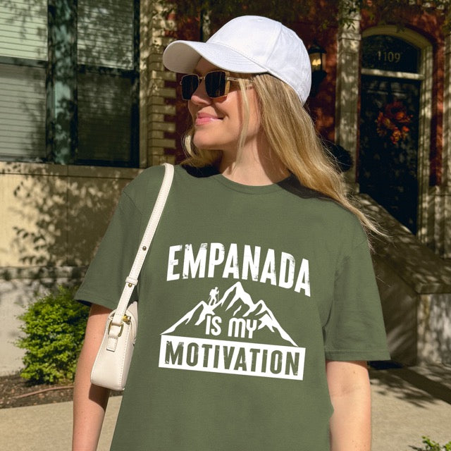 Woman wearing military green Empanada is my Motivation statement t-shirt with bold distressed typography, mountain peaks, and hiker silhouette for empanada lovers and outdoor enthusiasts on Softstyle 100% cotton