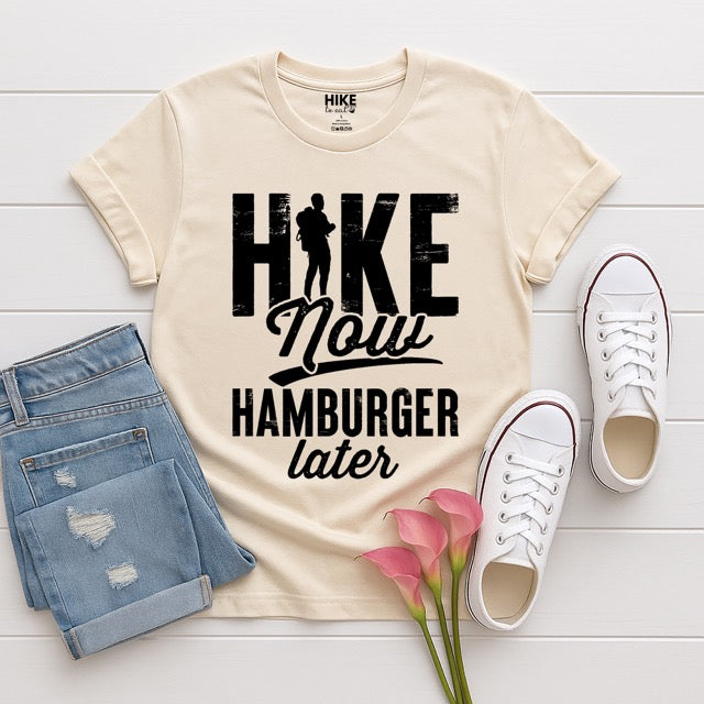 Natural (beige) color Empanada is my Motivation statement t-shirt with bold distressed typography, mountain peaks, and hiker silhouette for empanada lovers and outdoor enthusiasts on Softstyle 100% cotton, flat layed with pants and shoes