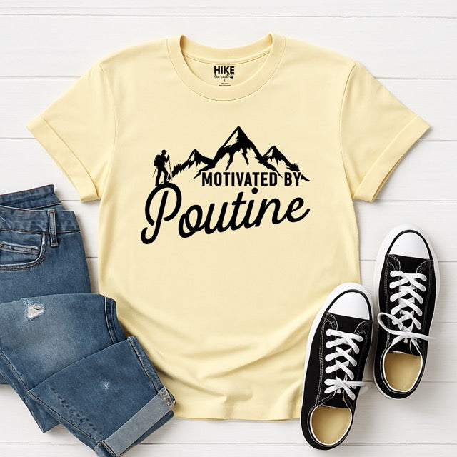 Cornsilk (yellow) Motivated by Poutine statement tee with distressed typography, mountain peaks, and hiker silhouette for poutine lovers and canadian food lovers, flat lay with pants and shoes