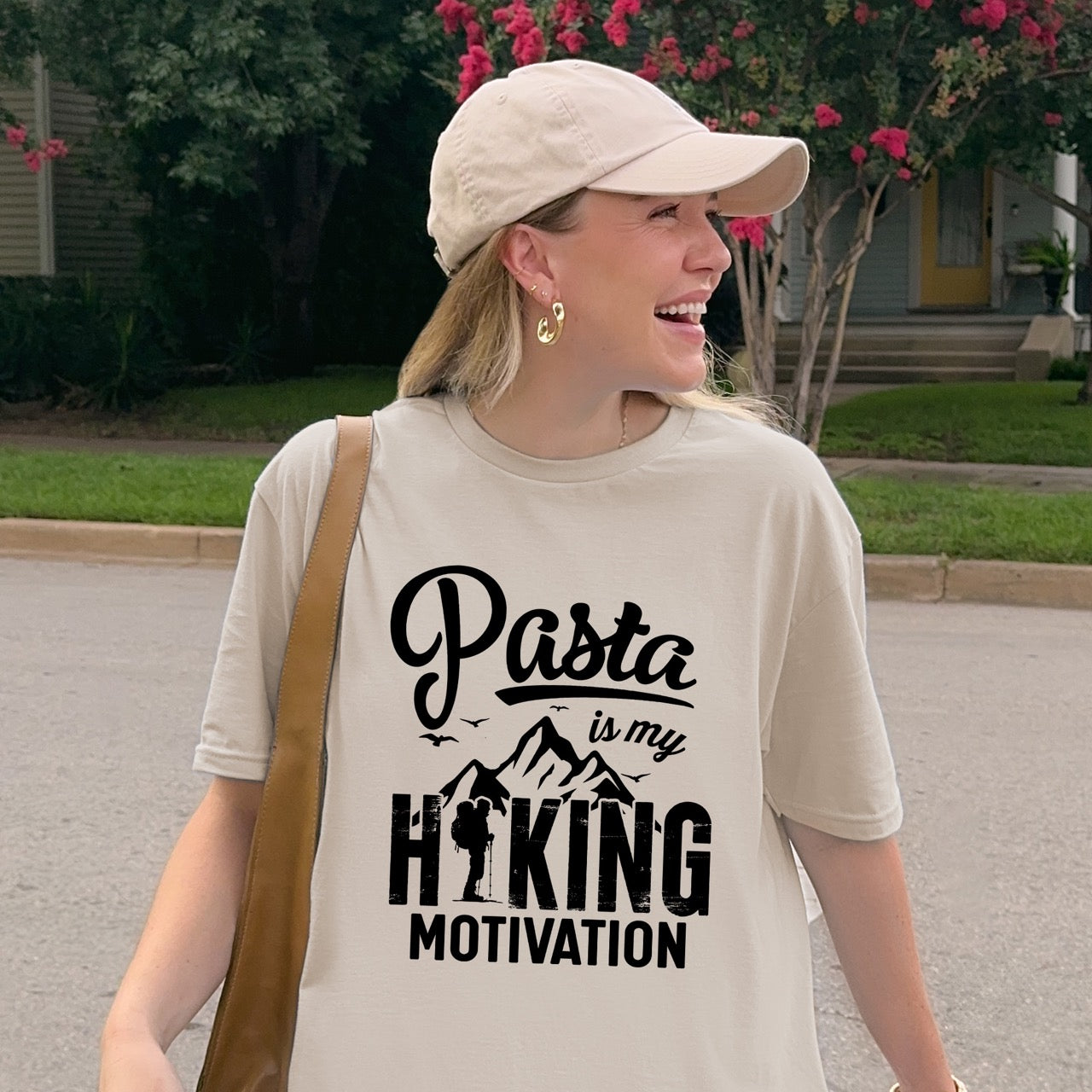 woman wearing sand (beige) Pasta is my Hiking Motivation statement tee with script typography, mountains, birds, and backpacker for pasta lovers