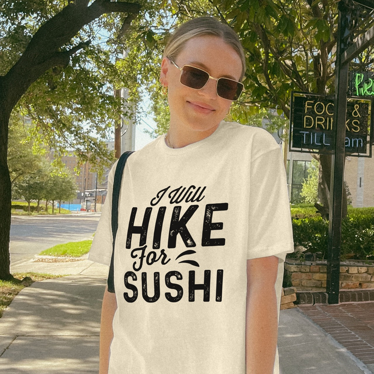 woman wearing natural (beige) I Will Hike for Sushi statement tee with distressed bold typography and elegant script lettering for Japanese food-loving outdoor enthusiasts and hikers