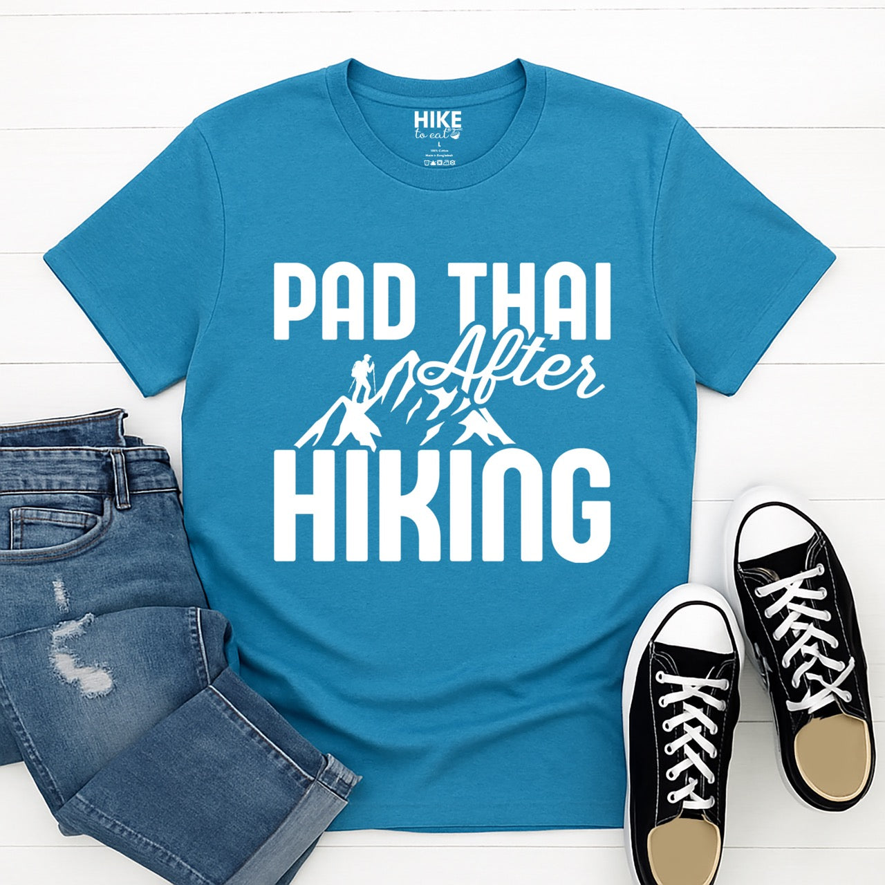 saphire (blue) Pad Thai after Hiking statement tee with bold typography, elegant script lettering, mountain peaks, and hiker silhouette for Thai food-loving outdoor enthusiasts, foodies and hikers pants and shoes