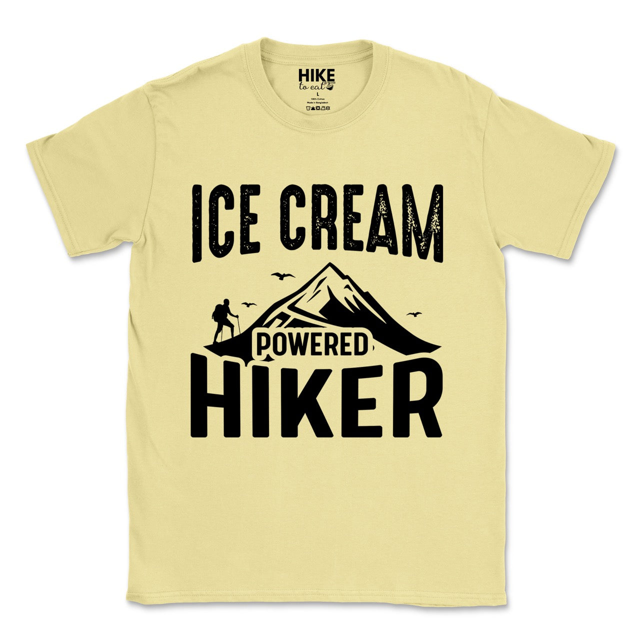 Cornsilk color (yellow) Ice Cream Powered Hiker statement tee with bold distressed typography, mountain peaks, hiker silhouette, and flying birds for dessert-loving outdoor enthusiasts, hikers and foodies