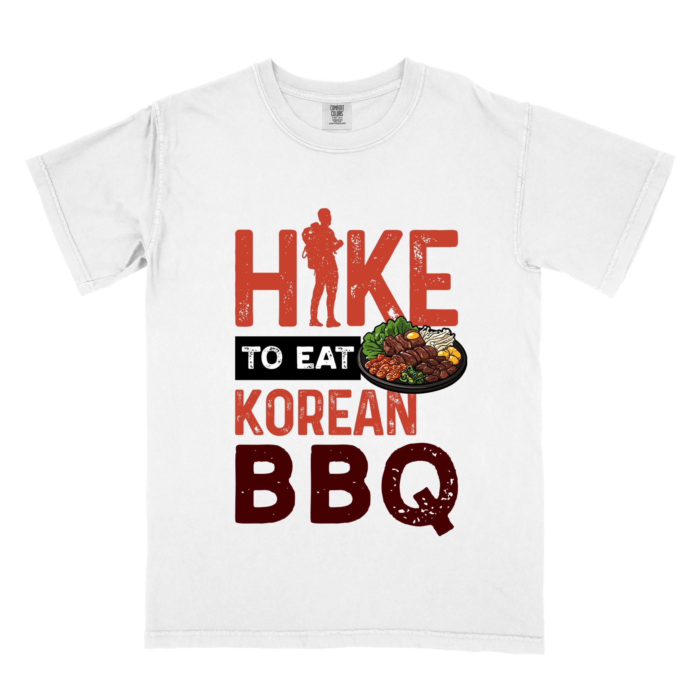 White "Hike to eat Korean bbq" colored vintage tee with bold typography, illustrated grilling platter korean bbq, mountains, birds, and backpacker for kbbq lovers.