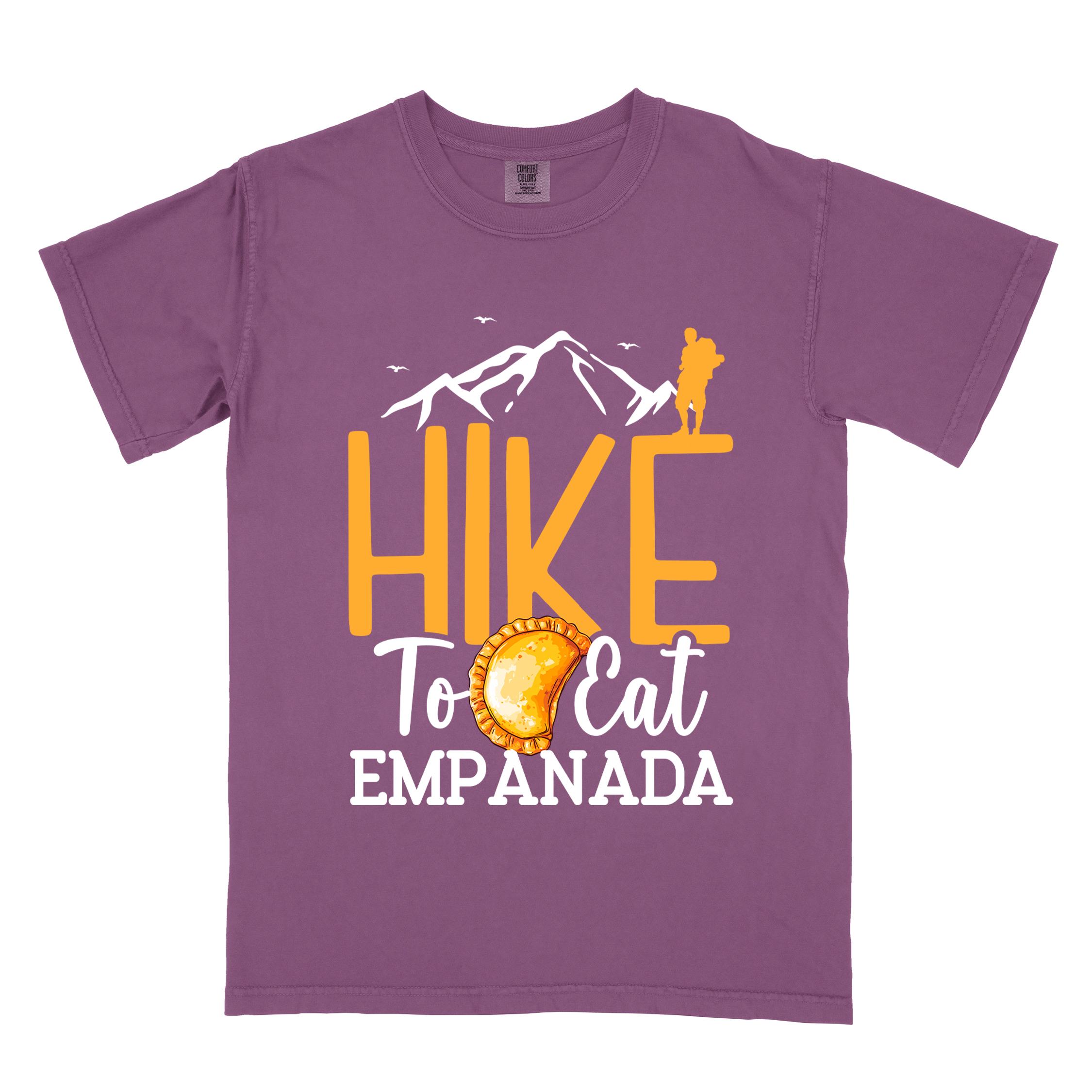 Berry "Hike to eat empanada" colored vintage tee with bold typography, illustrated freshly baked empanada, mountains, birds, and backpackers for street food enthusiasts.