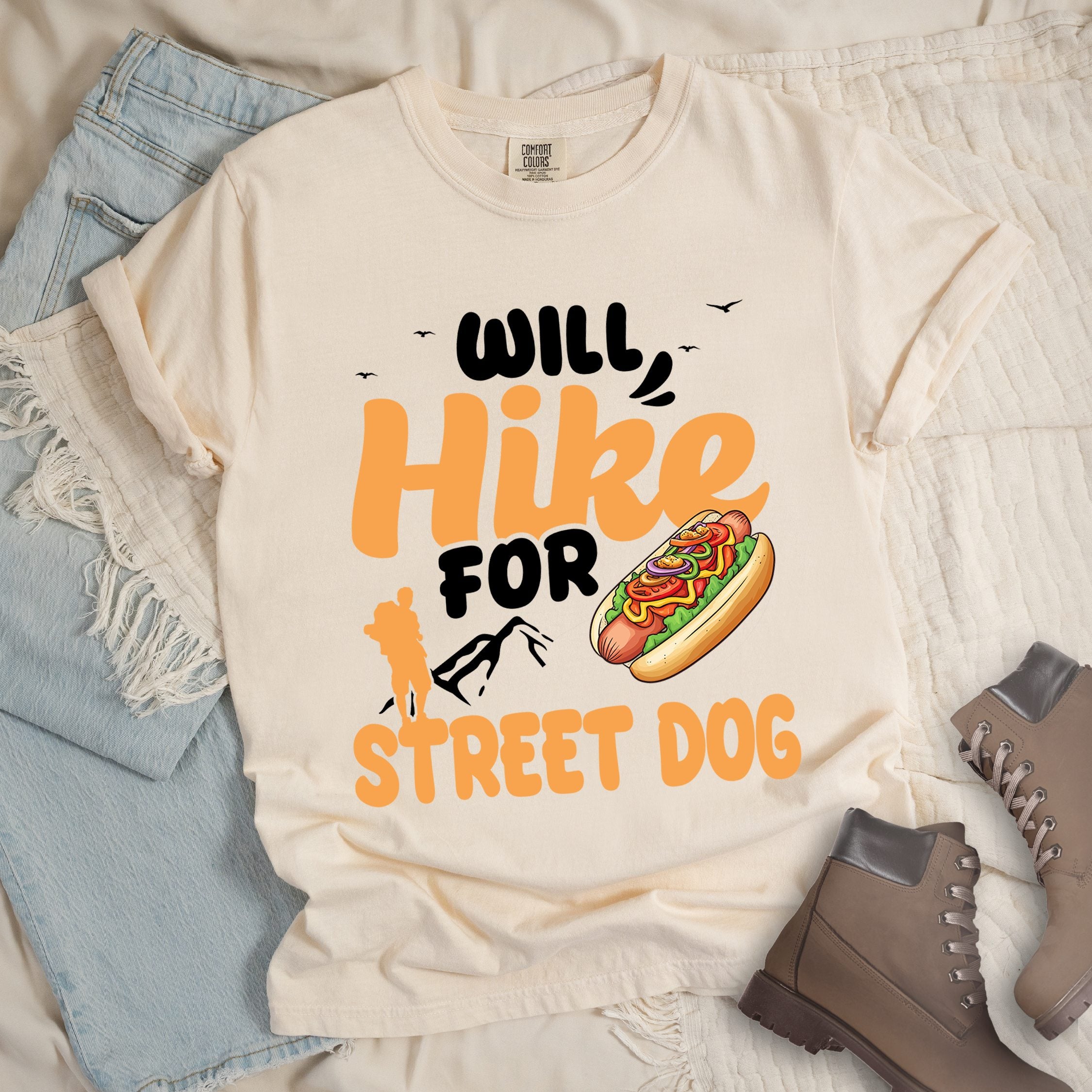 Ivory shirt with Hiking Design featuring the phrase “Will Hike for Street Dog” and an illustration of a hot dog with toppings.
