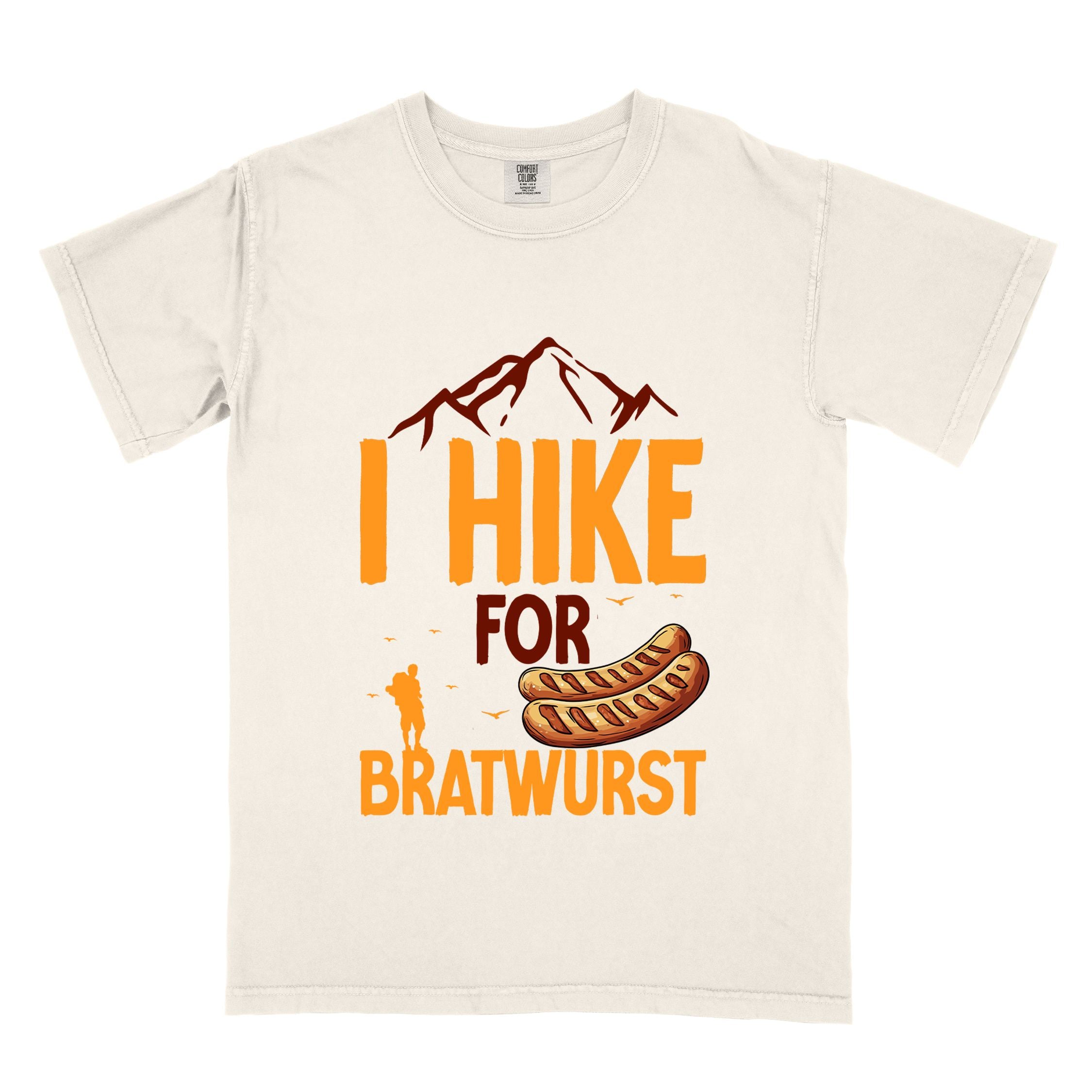 Ivory "I hike for bratwurst" colored vintage tee with bold typography, illustrated bratwurst, mountains, birds, and backpackers for street dog lovers.