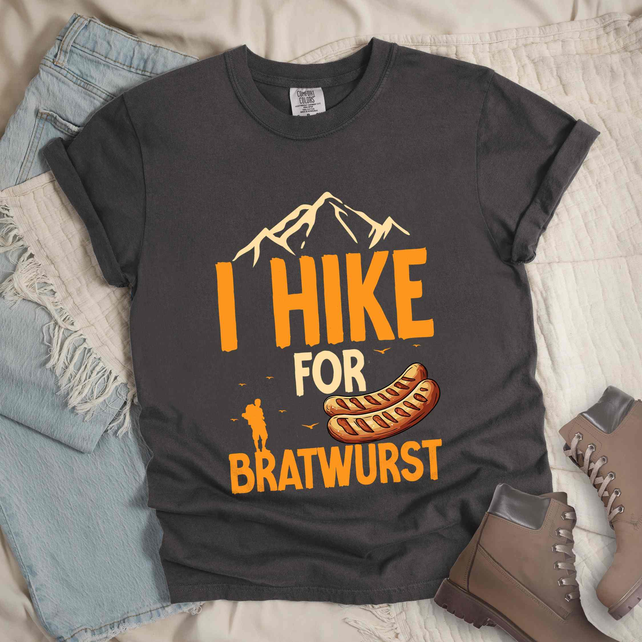 Pepper "I hike for bratwurst" colored vintage tee with bold typography, illustrated bratwurst, mountains, birds, and backpackers for street dog lovers.