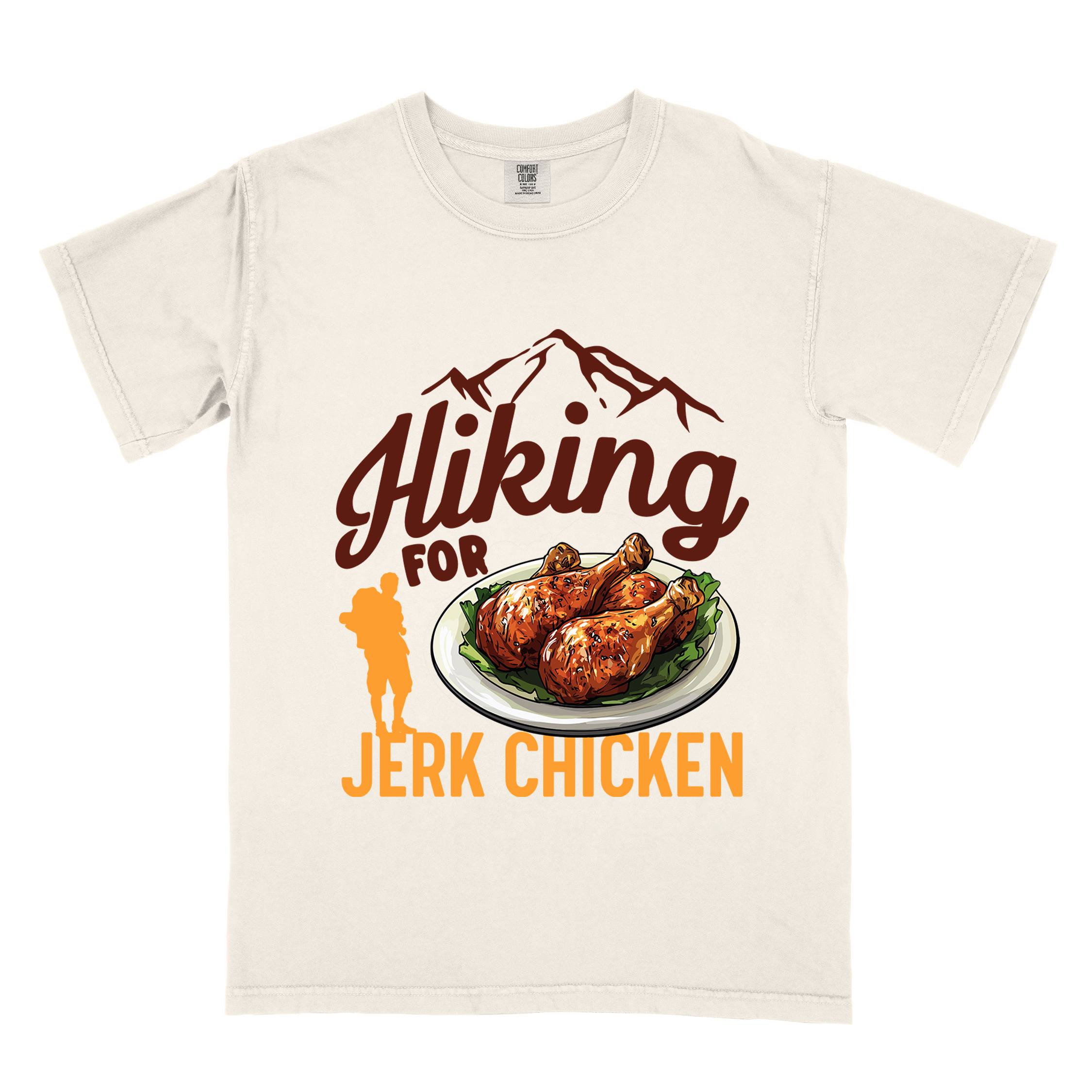 Ivory "hiking for jerk chicken" colored vintage tee with bold typography, illustrated jerk chicken on a plate, mountains, birds, and backpackers for bbq chicken lovers.