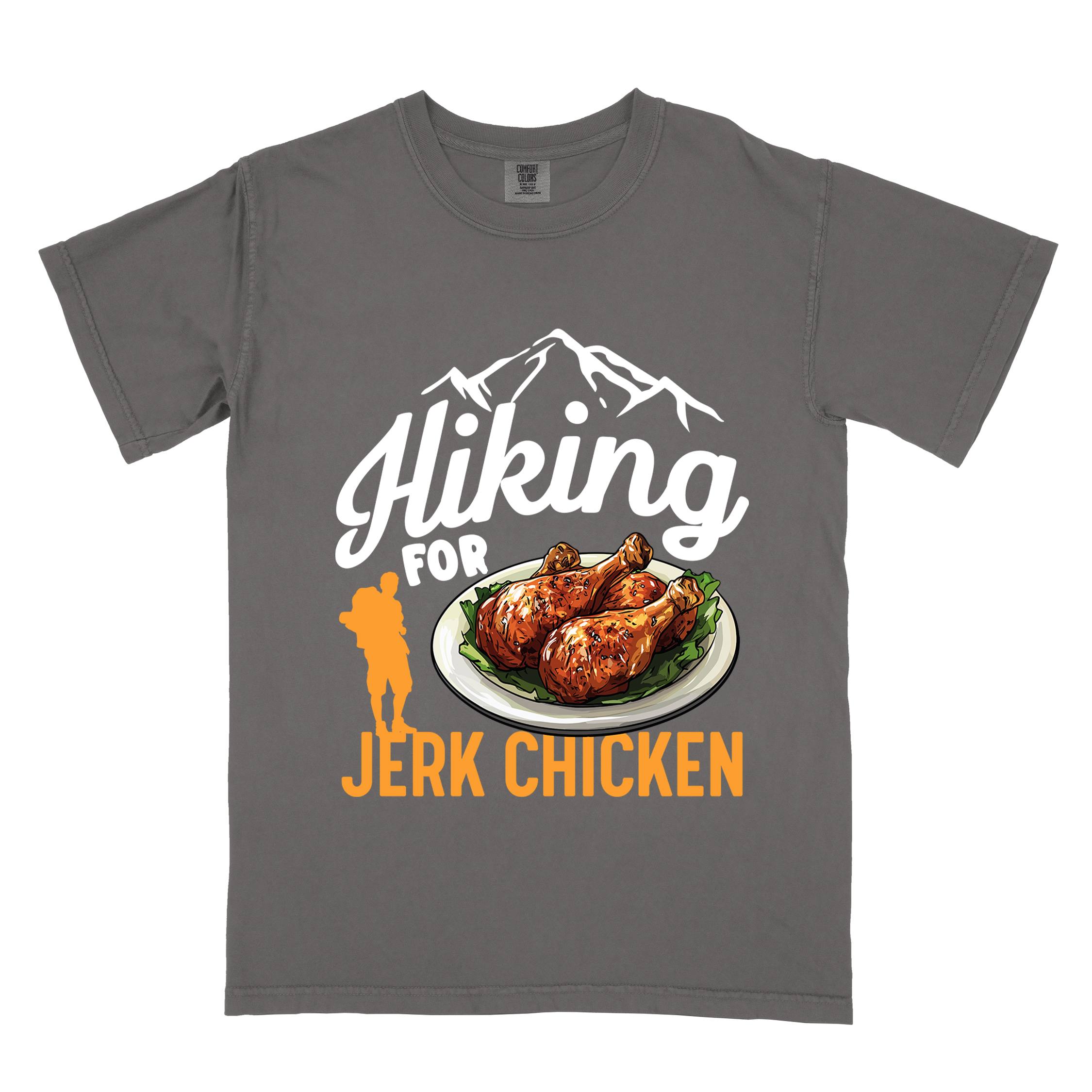 Pepper "hiking for jerk chicken" colored vintage tee with bold typography, illustrated jerk chicken on a plate, mountains, birds, and backpackers for bbq chicken lovers.