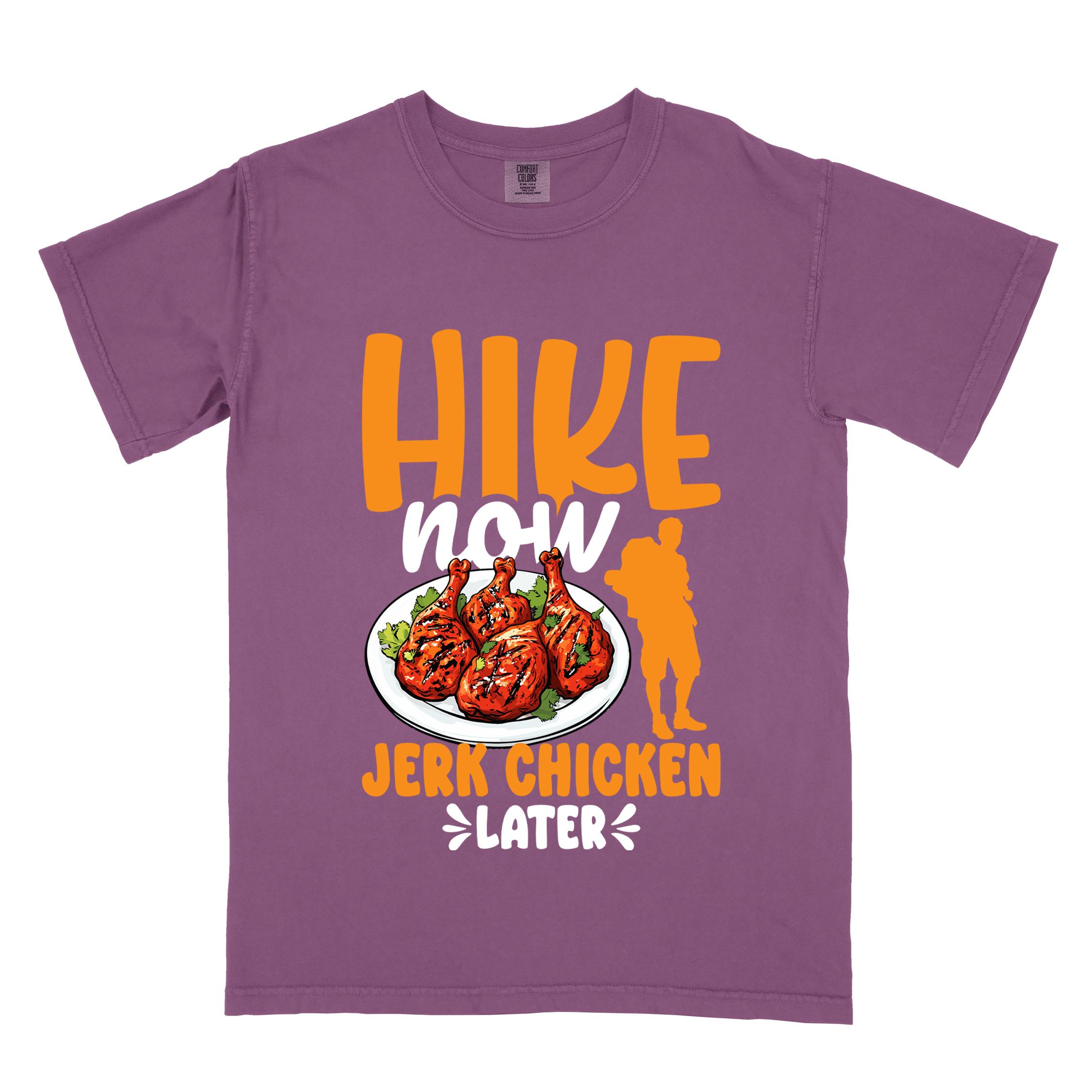Berry "hike now jerk chicken later" colored vintage tee with bold typography, illustrated jerk chicken on a plate, mountains, birds, and backpackers for bbq chicken lovers.