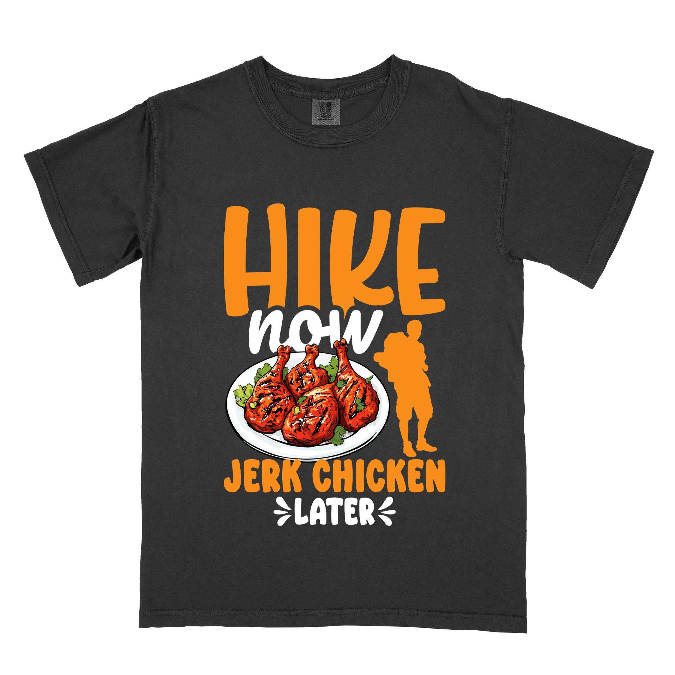 Black "hike now jerk chicken later" colored vintage tee with bold typography, illustrated jerk chicken on a plate, mountains, birds, and backpackers for bbq chicken lovers.