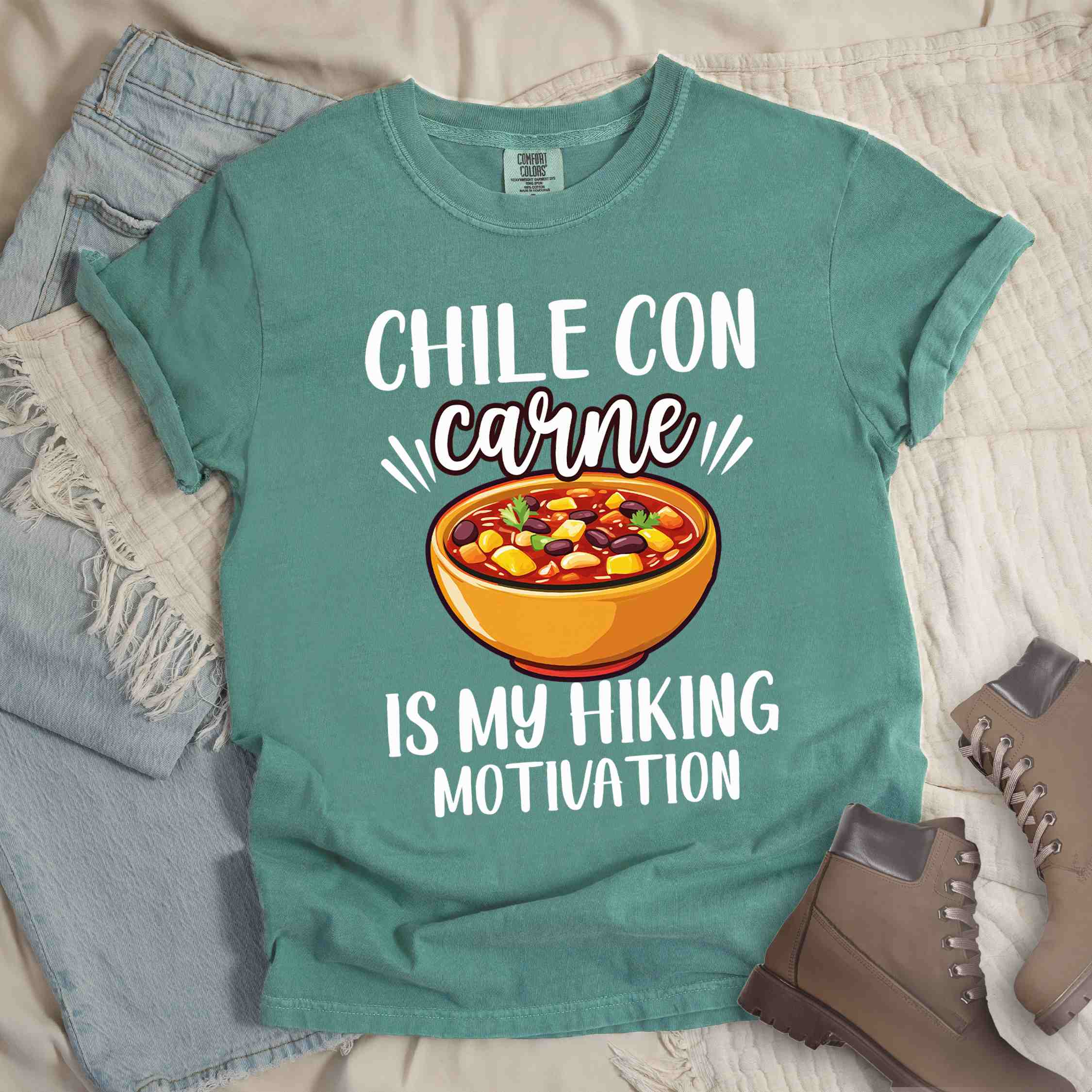 Light green Chile con carne is my Hiking Motivation statement tee with bold typography, script lettering, and colorful chili bowl illustration for comfort food-loving outdoor enthusiasts