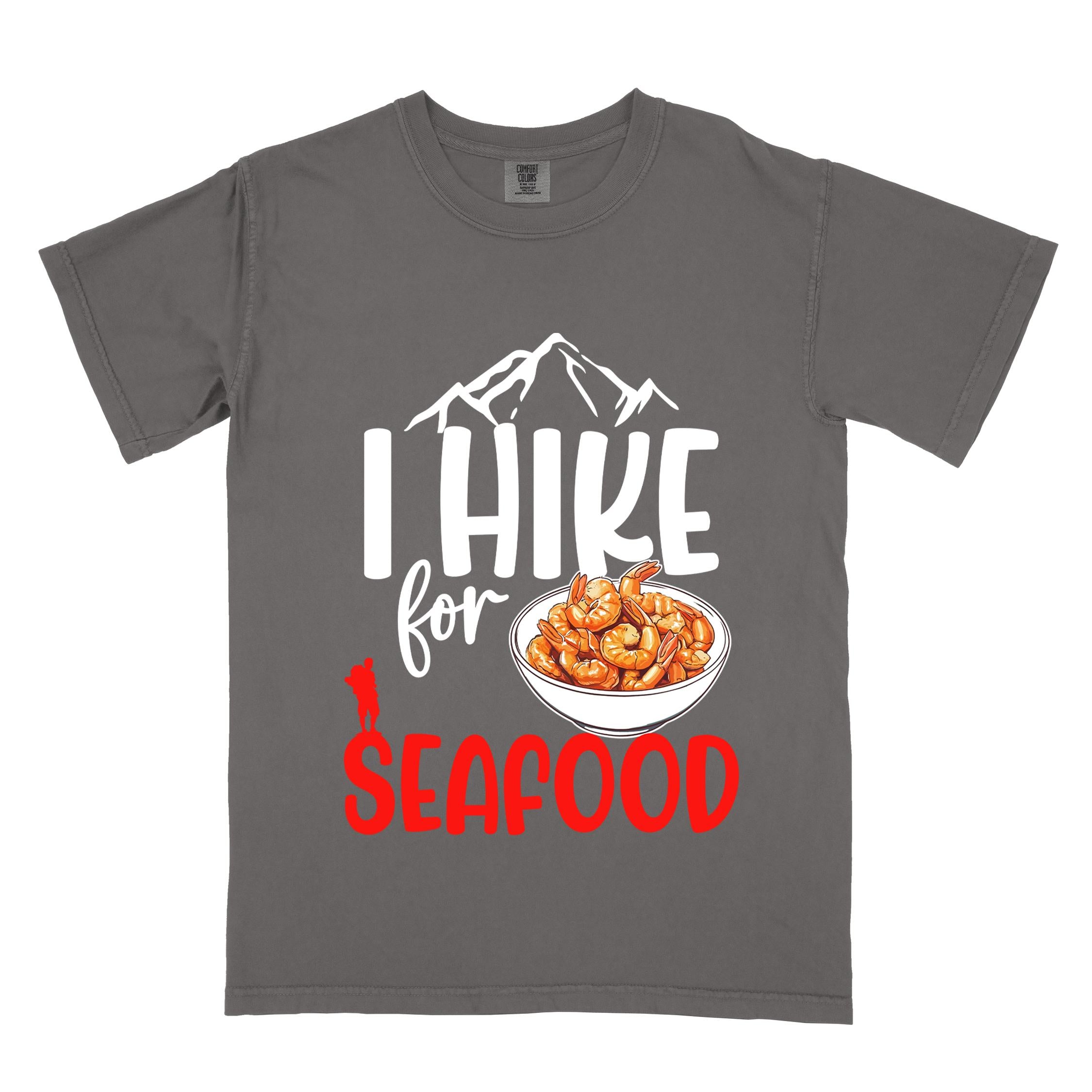 Pepper "I hike for seafood" colored vintage tee with bold typography, illustrated shrimps on a bowl, mountains, birds, and backpackers for seafood lovers.