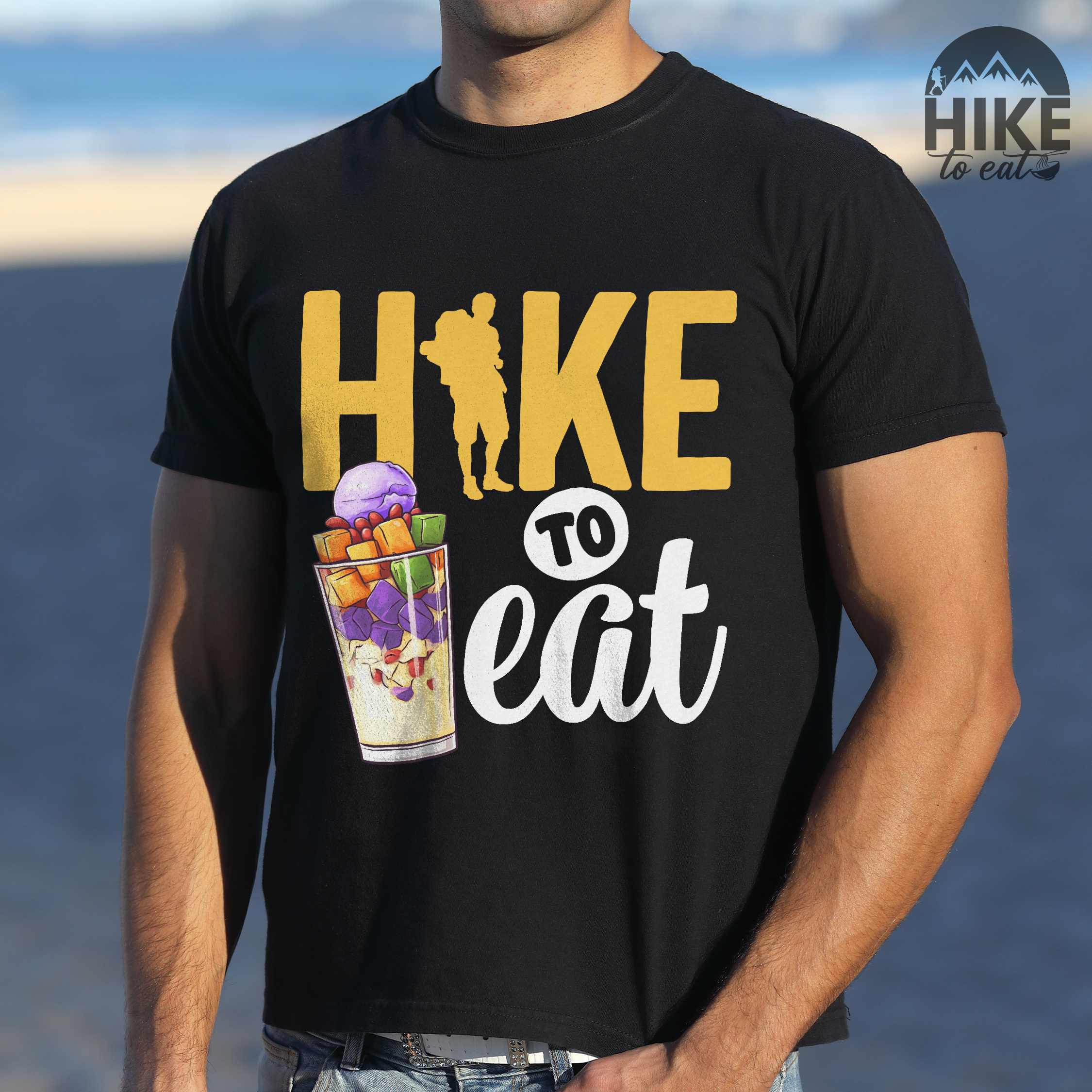 Man wearing black "hike to eat" colored vintage tee with bold typography, illustrated halo-halo dessert, and backpackers for iced dessert lovers.