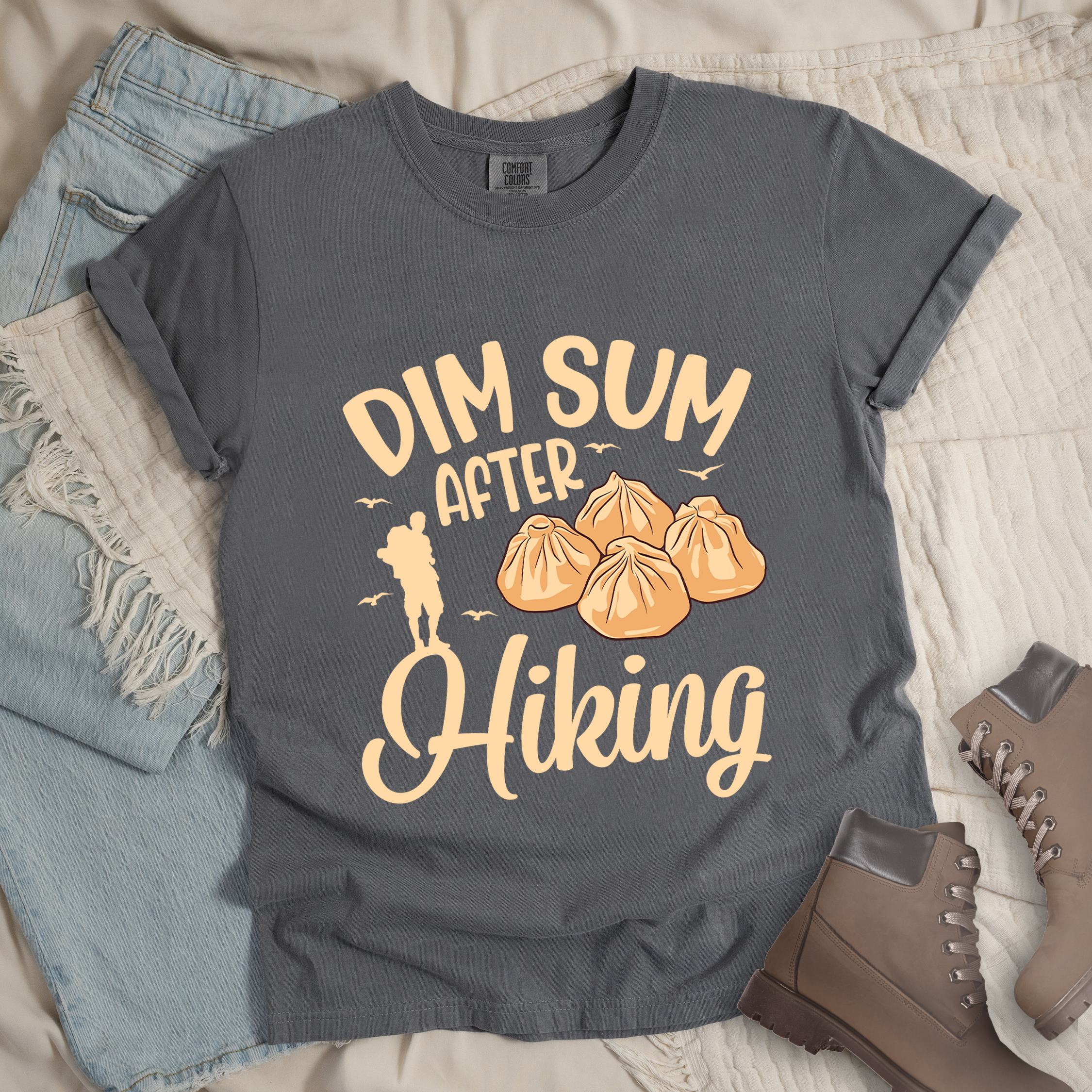 Grey shirt with Hiking Design featuring the phrase “Dim Sum After Hiking” with a hiker silhouette and a group of dim sum buns.