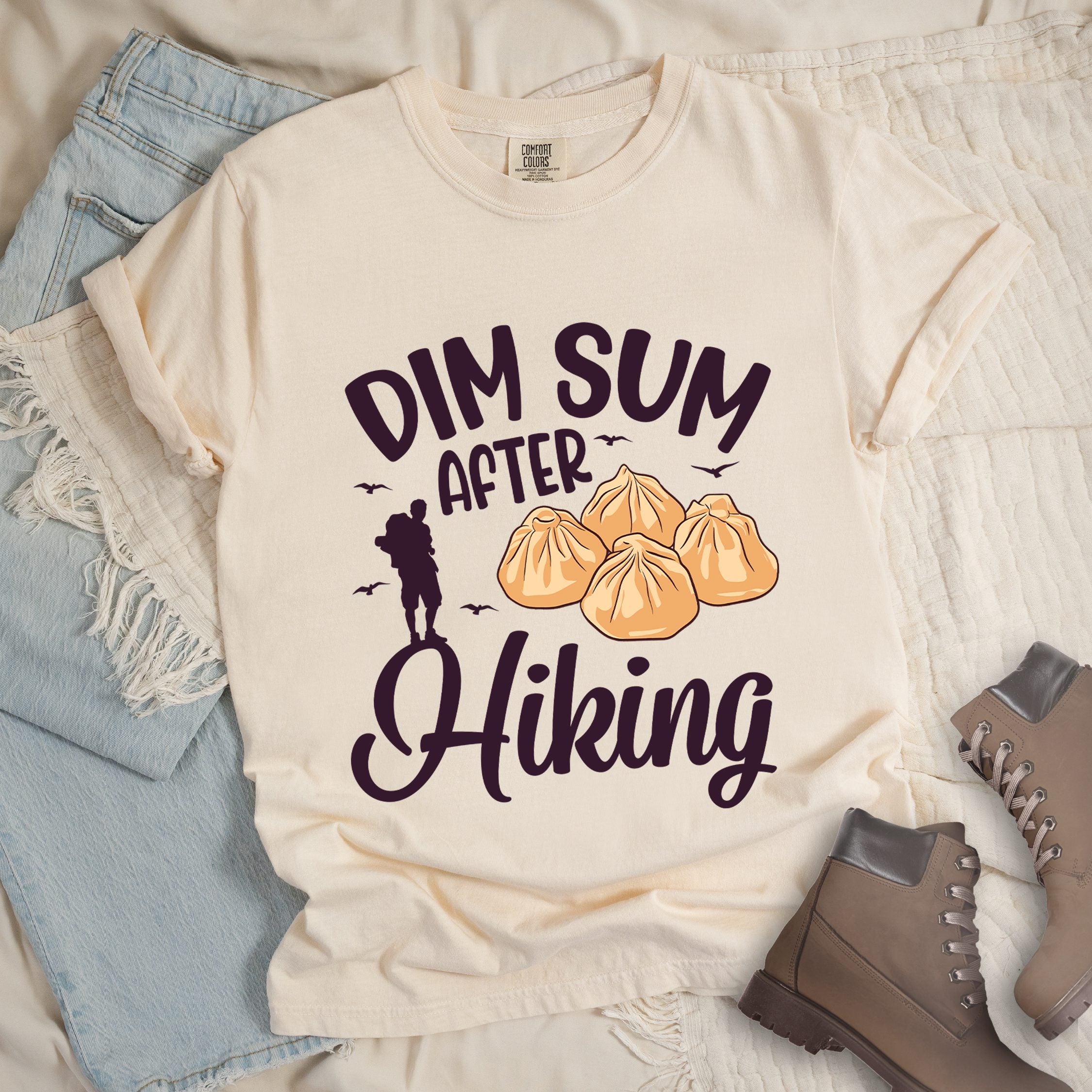 Ivory shirt with Hiking Design featuring the phrase “Dim Sum After Hiking” with a hiker silhouette and a group of dim sum buns.