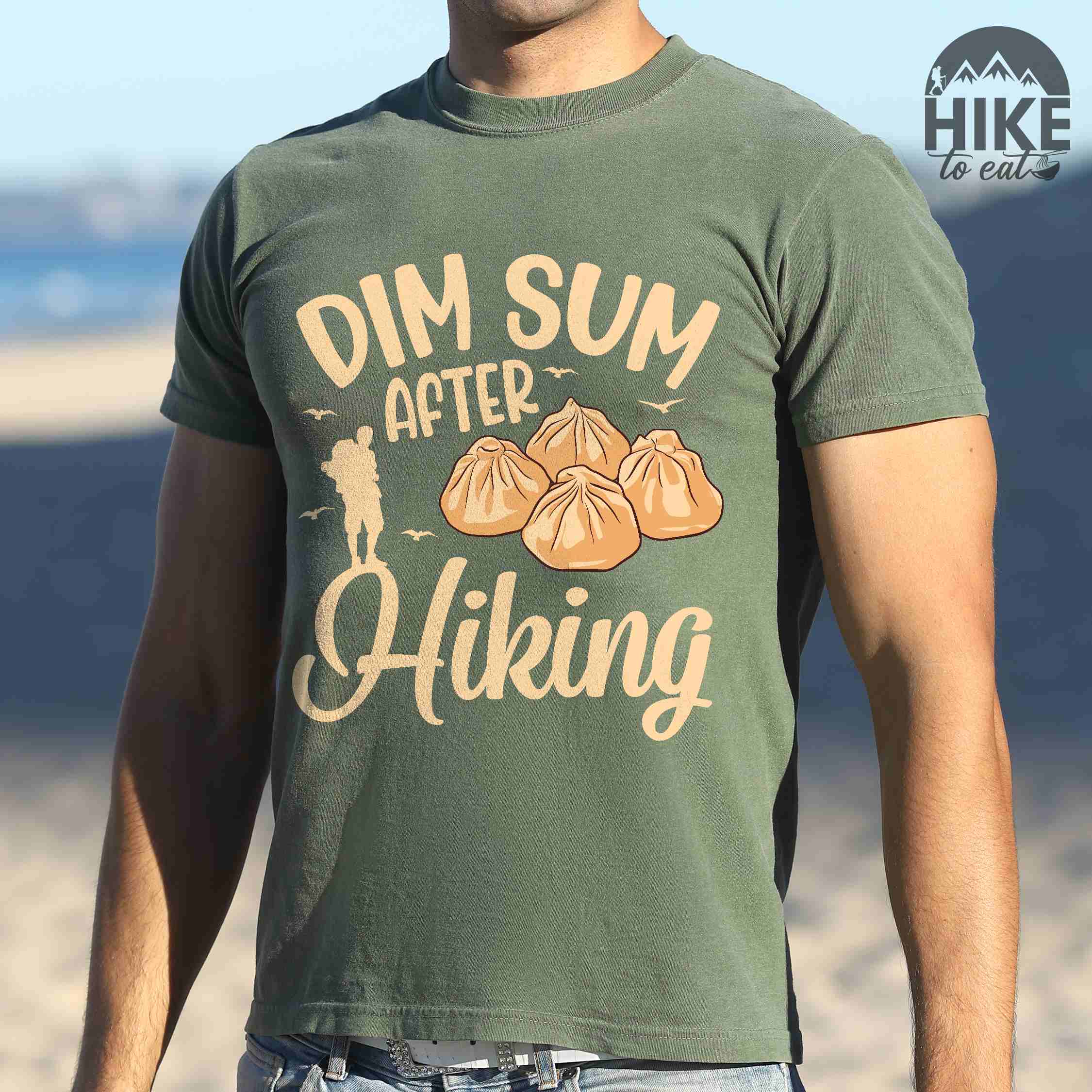 Man wearing moss "dim sum after hiking" colored statement tee with bold typography, and steamed dim sum illustration for dim sum-loving outdoor enthusiasts, hikers and foodies