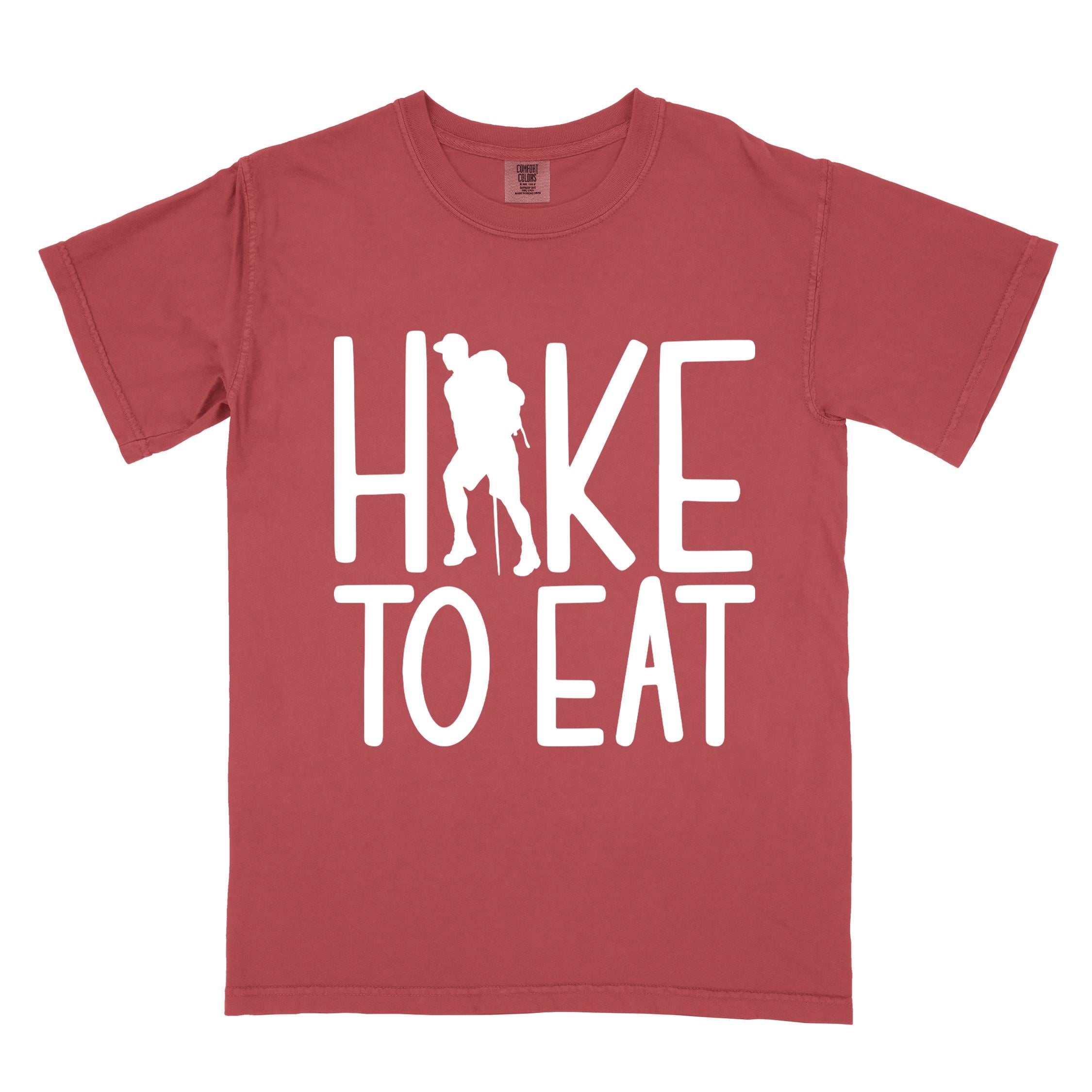Crimson "Hike to Eat" colored statement tee with bold typography, perfect for food motivated individuals.