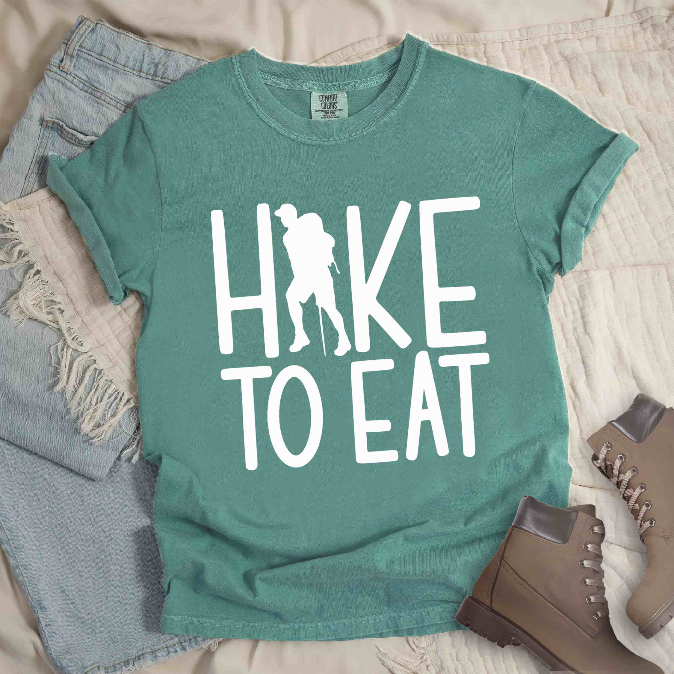 Light green "Hike to Eat" colored statement tee with bold typography, perfect for food motivated individuals.