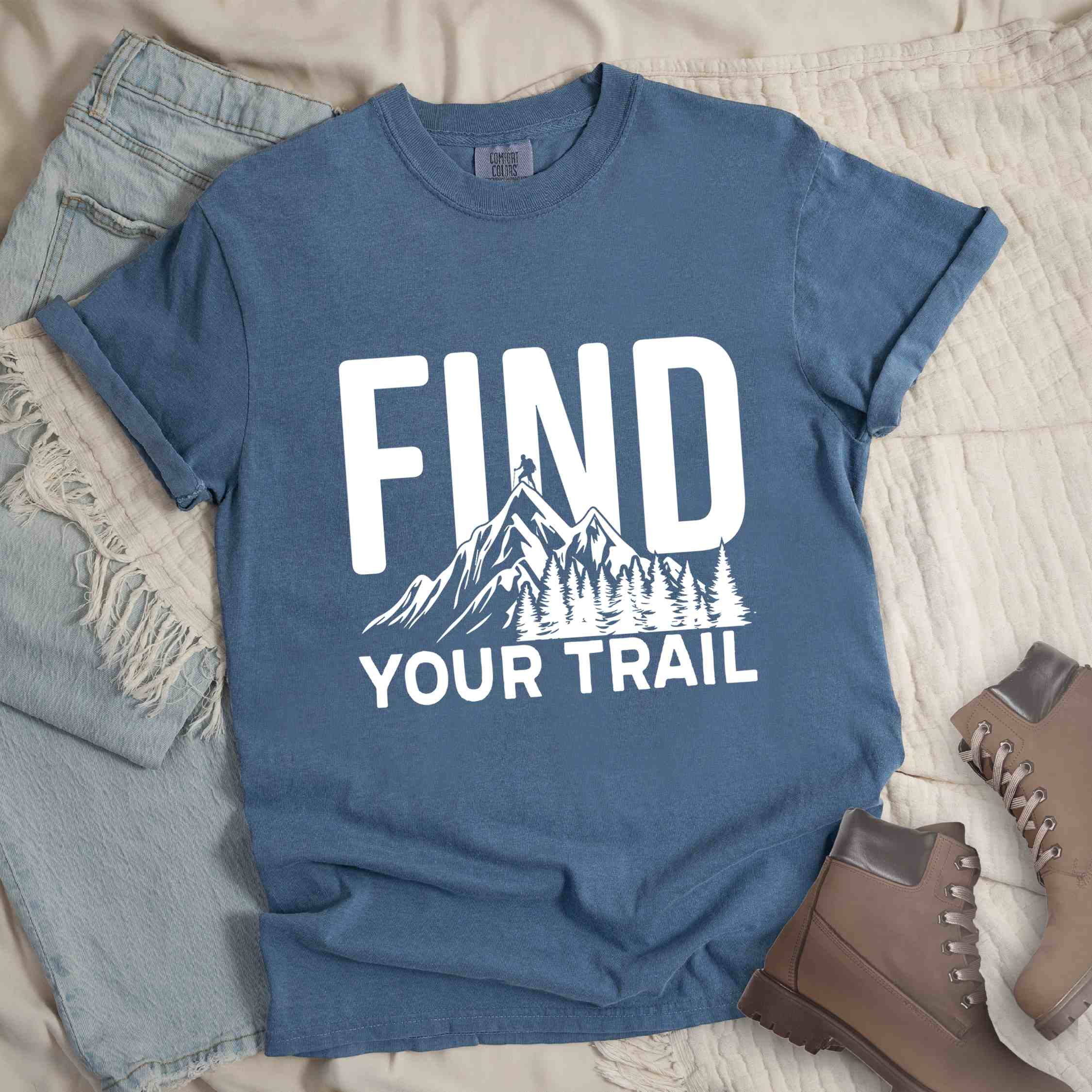 Blue jean "Find your trail" colored statement tee with bold typography, mountains, birds, perfect for adventure motivated individuals.
