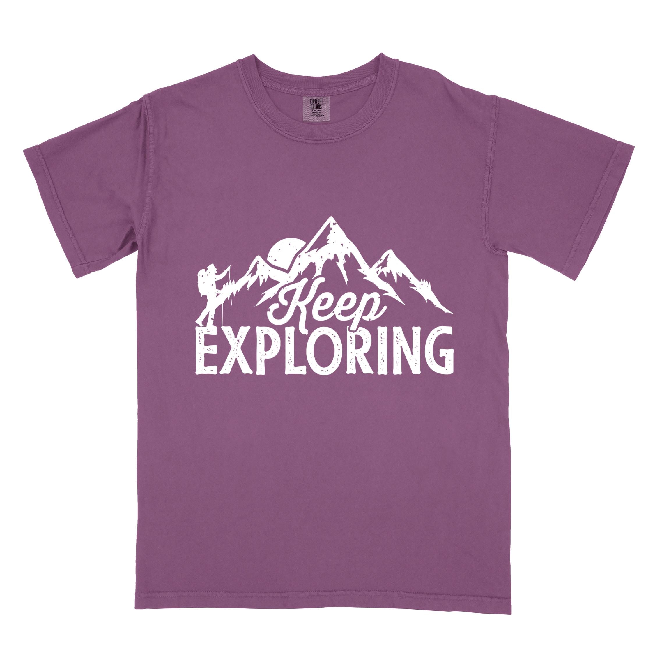 Berry "Keep Exploring" colored statement tee with bold typography, mountains, birds, perfect for adventure motivated individuals.
