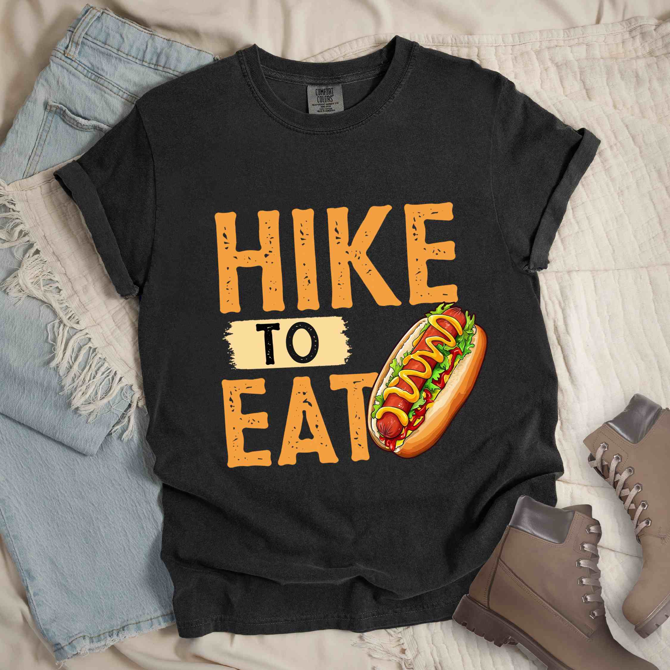 Graphite "Hike to Eat" colored vintage tee with bold typography, and illustrated hotdog with mustard and ketchup sauce.