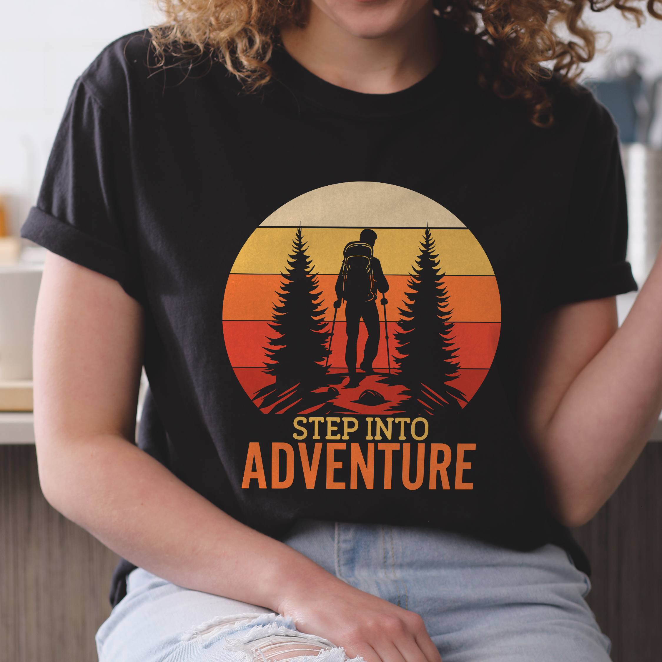 Woman wearing black "Step into adventure" colored statement tee with bold typography, mountain, sunrise, perfect for adventure motivated individuals.