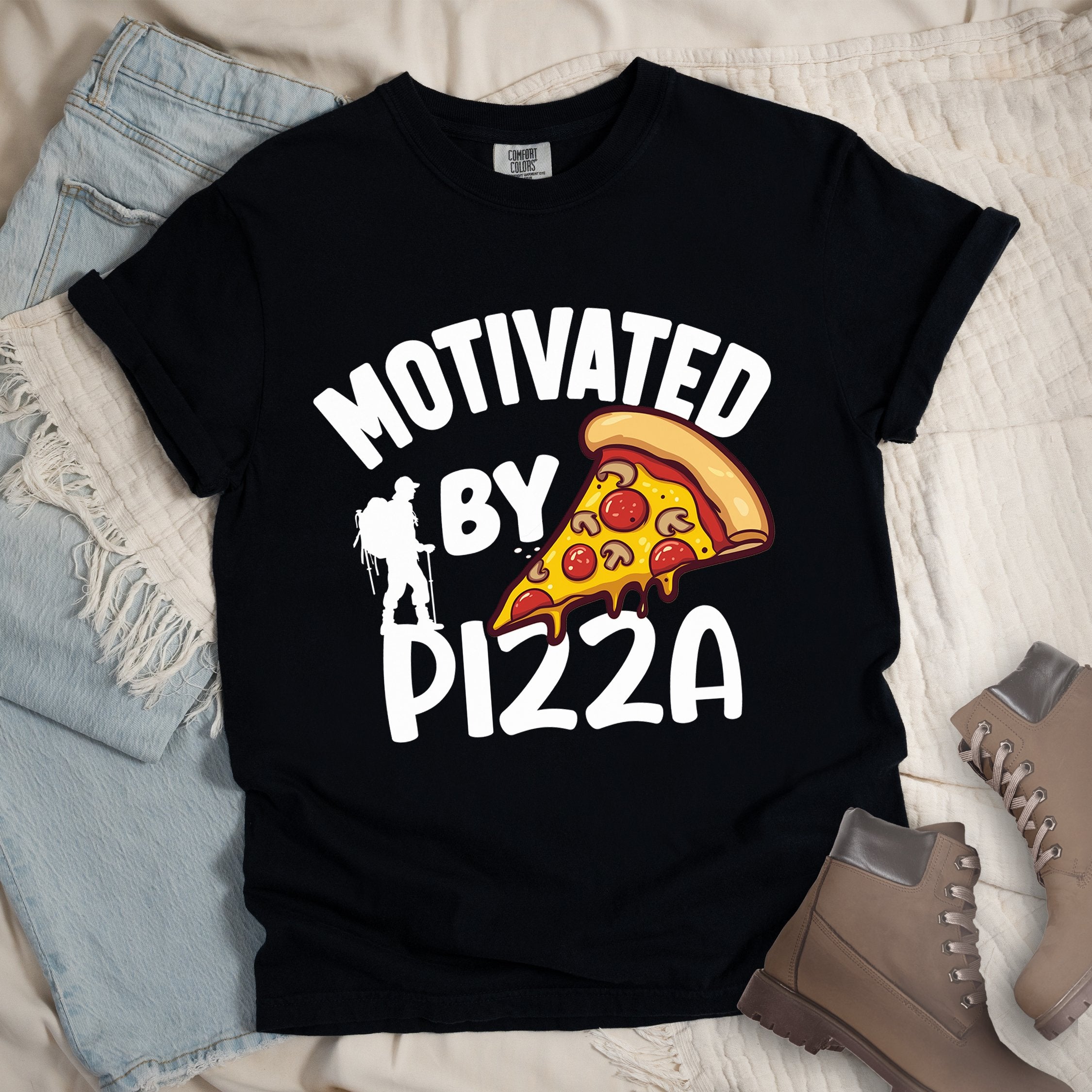Black shirt showing a hiking design with 'Motivated By Pizza' phrase and an illustration of a slice of pizza