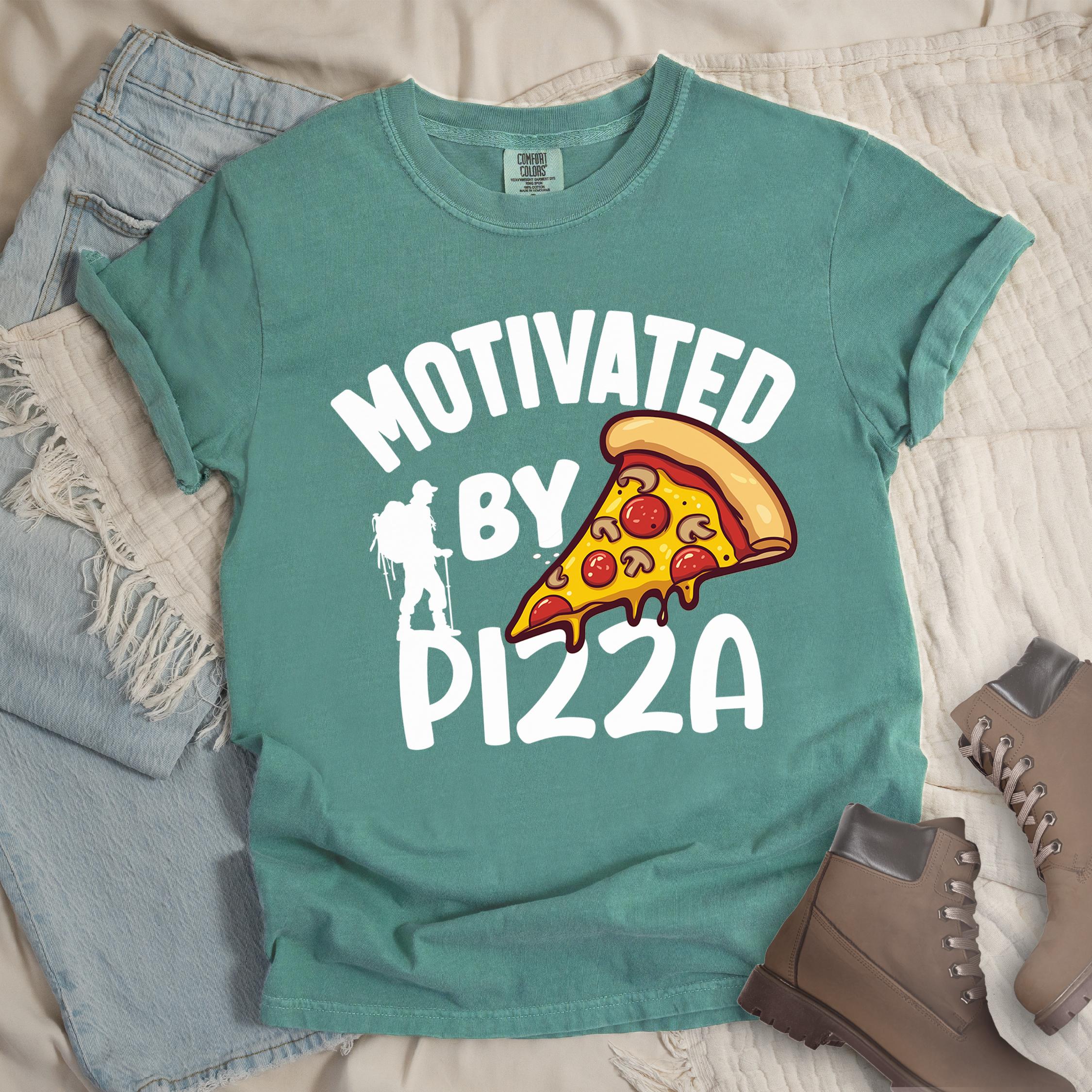 Green shirt showing a hiking design with 'Motivated By Pizza' phrase and an illustration of a slice of pizza
