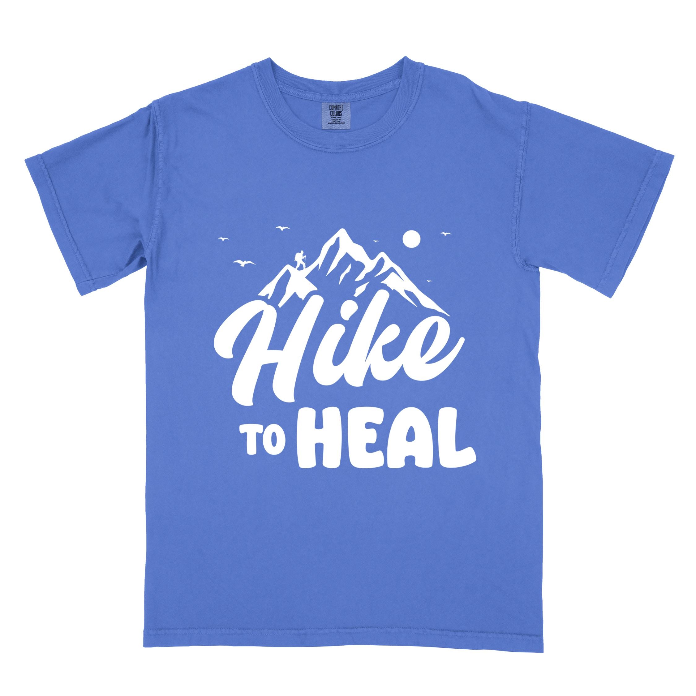 flo blue "Hike to Heal" colored statement tee with bold typography, mountain, sunrise, perfect for adventure driven individuals.