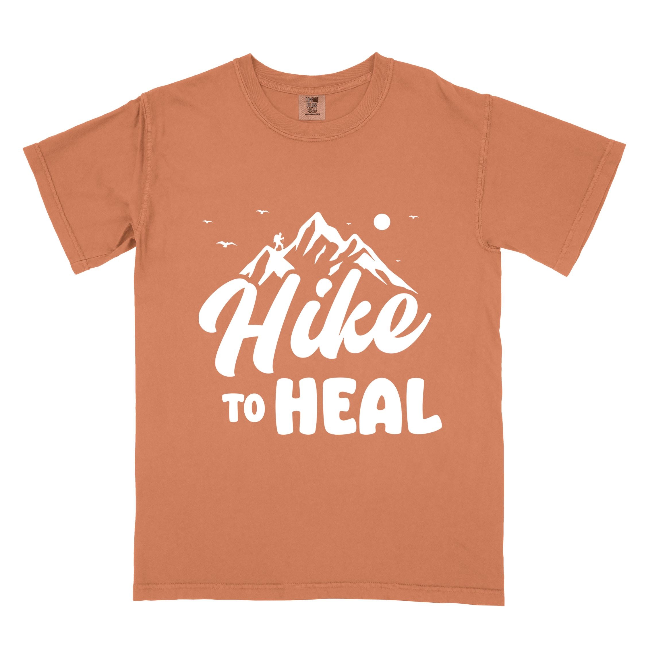 Yam "Hike to Heal" colored statement tee with bold typography, mountain, sunrise, perfect for adventure driven individuals.