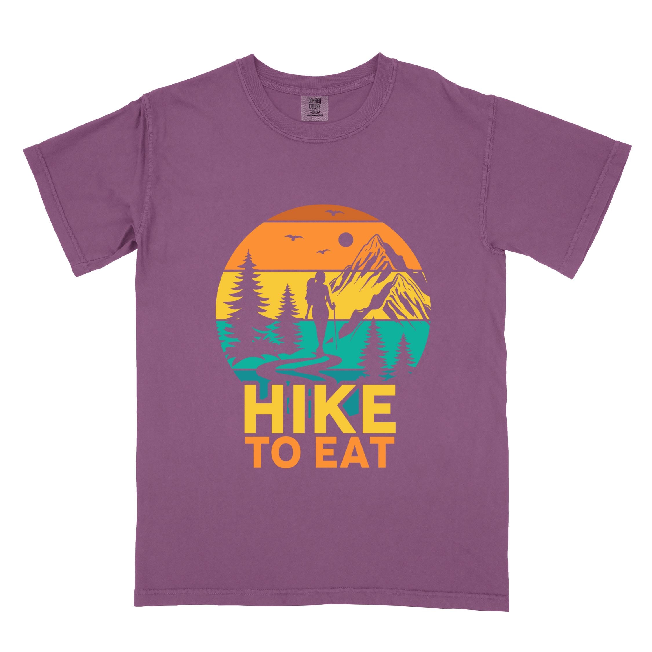 Berry "Hike to Eat" colored statement tee with bold typography, mountain, sunrise, perfect for adventure driven individuals.