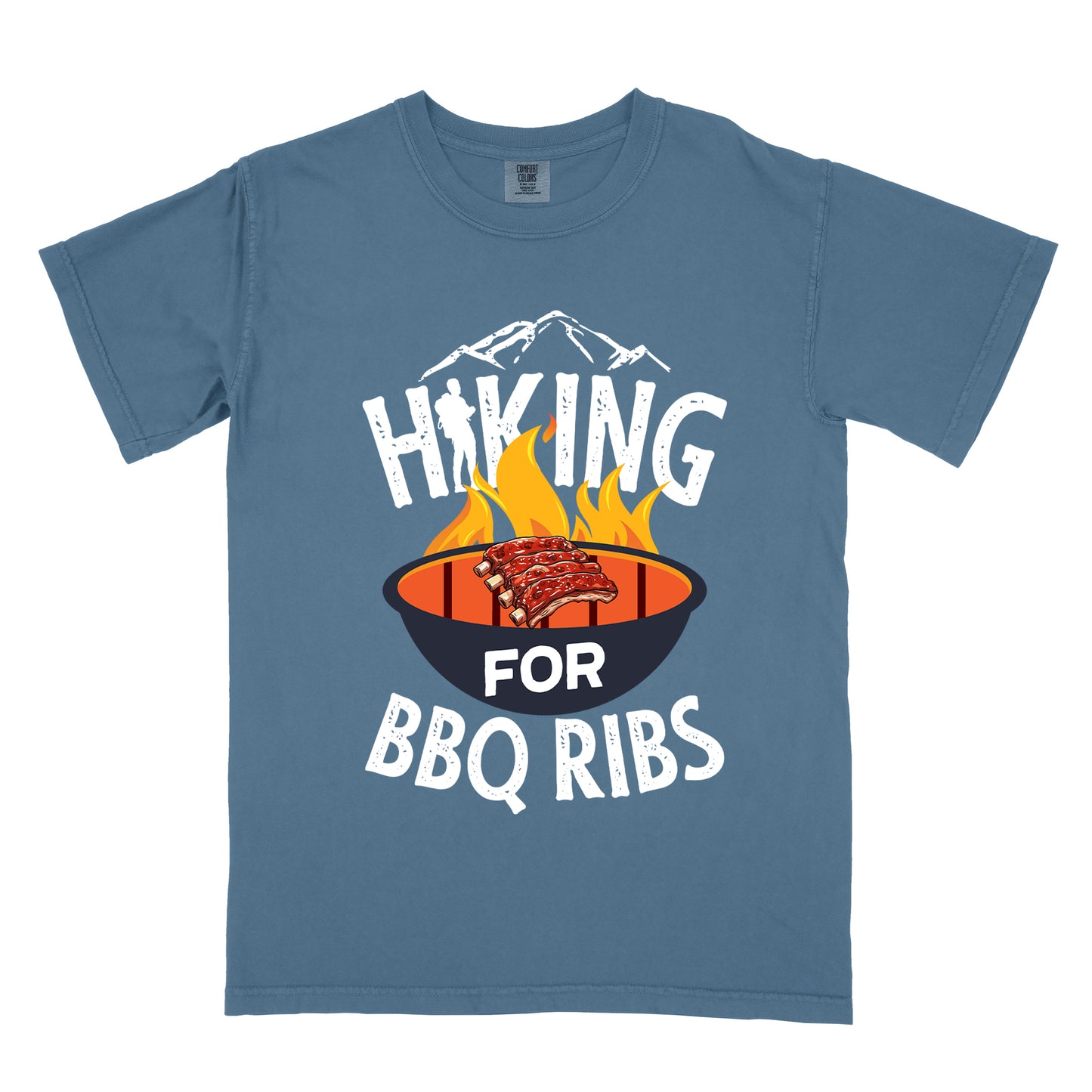 Blue Jean (Denim Blue) t-shirt with white distressed text reading "HIKING FOR BBQ RIBS". Mountain silhouettes appear above the word "HIKING". The letter "I" in "HIKING" features a hiker silhouette. Between "HIKING" and "BBQ RIBS" is an illustration of a grill with flames and a rack of ribs cooking. The word "FOR" appears in white on the grill.