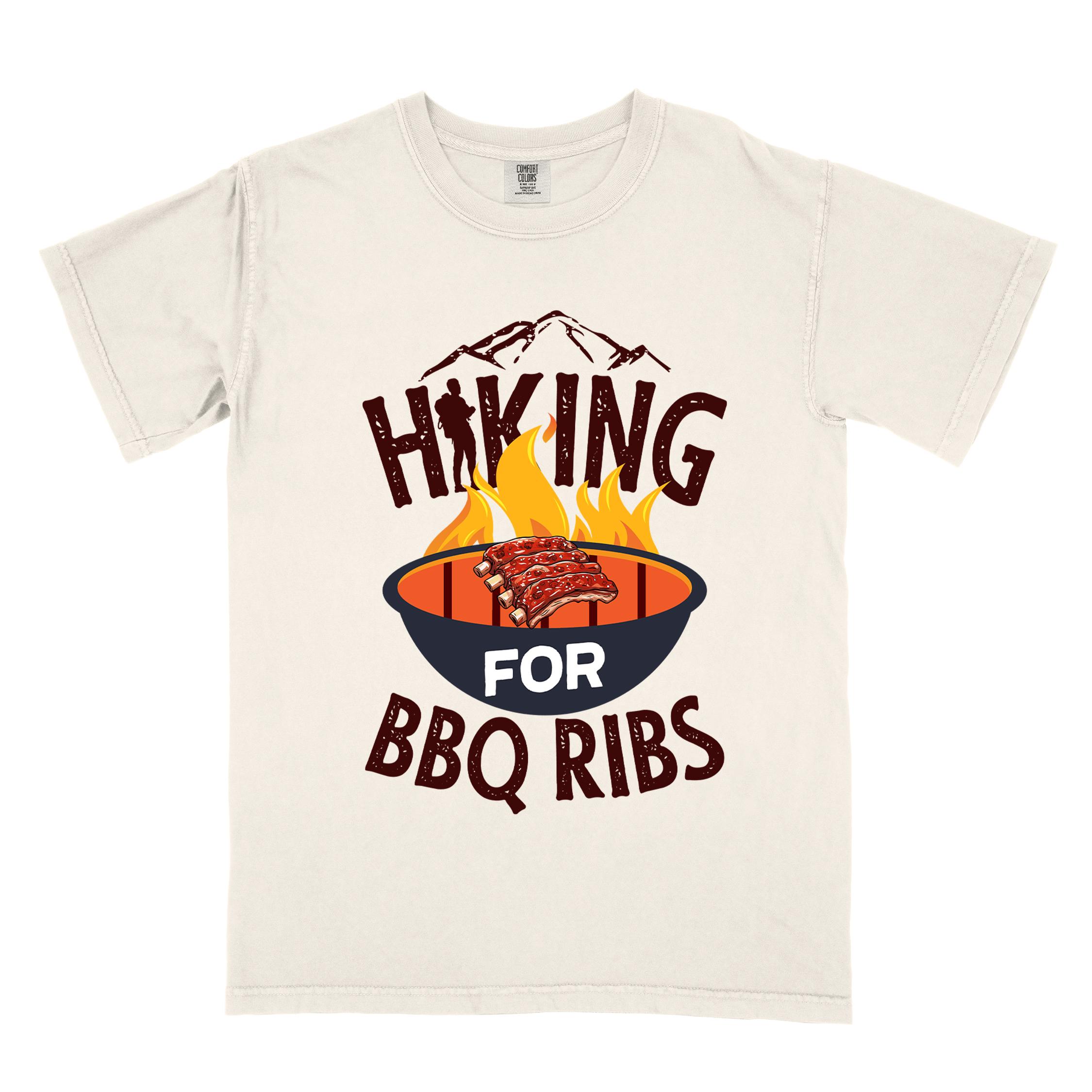 Ivory Hiking for BBQ ribs colored vintage tee with bold typography, illustrated grilling bbq ribs, mountains, birds, and bbq enthusiasts