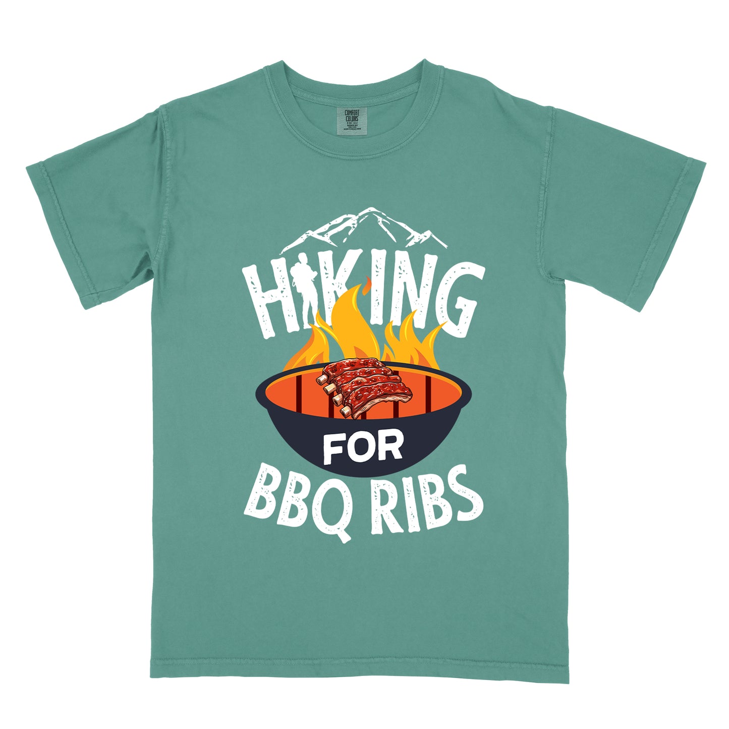 Light Green t-shirt with white distressed text reading "HIKING FOR BBQ RIBS". Mountain silhouettes appear above the word "HIKING". The letter "I" in "HIKING" features a hiker silhouette. Between "HIKING" and "BBQ RIBS" is an illustration of a grill with flames and a rack of ribs cooking. The word "FOR" appears in white on the grill.