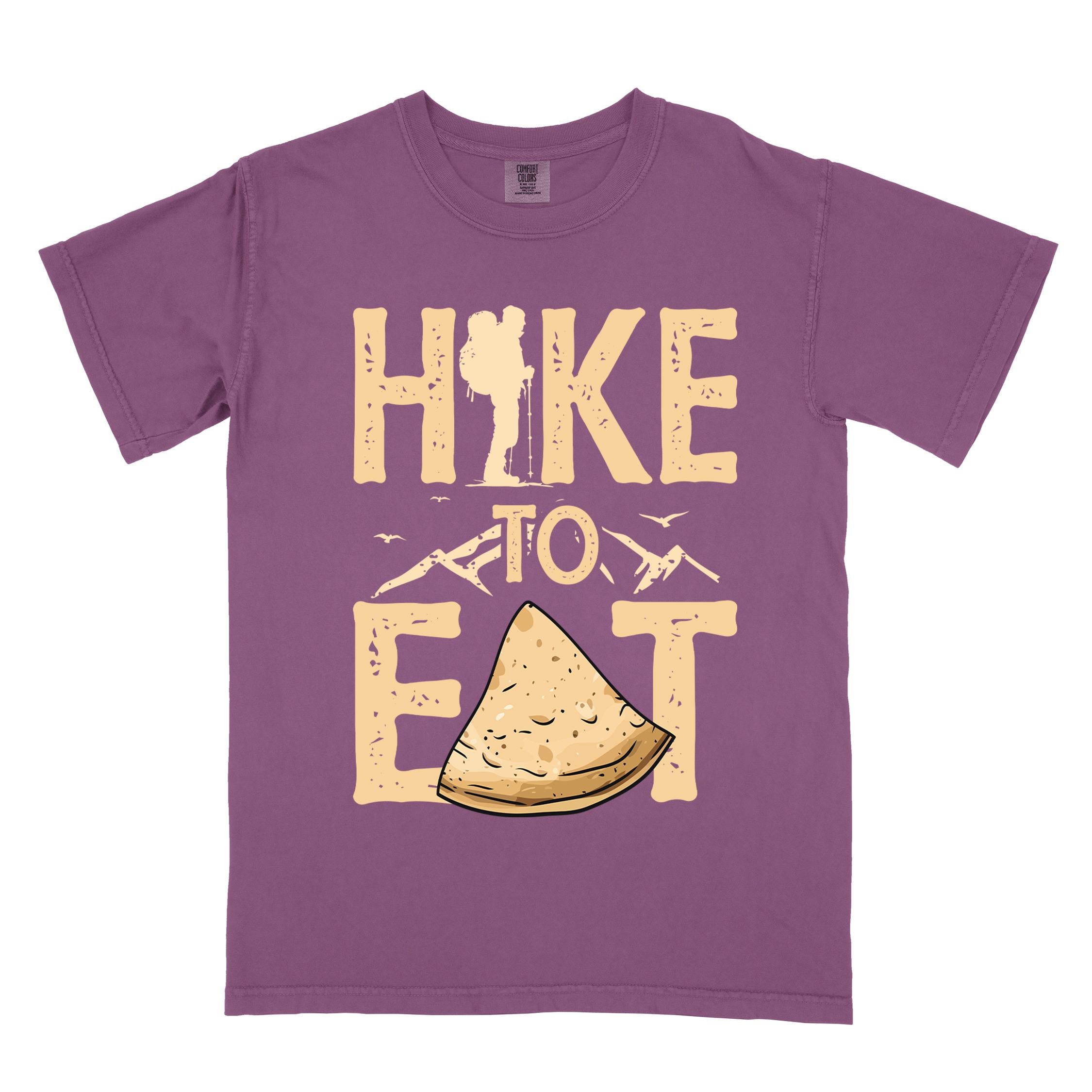 Berry "Hike to Eat" colored statement tee with bold typography, mountain, illustrated tortilla, perfect for tortilla lovers.