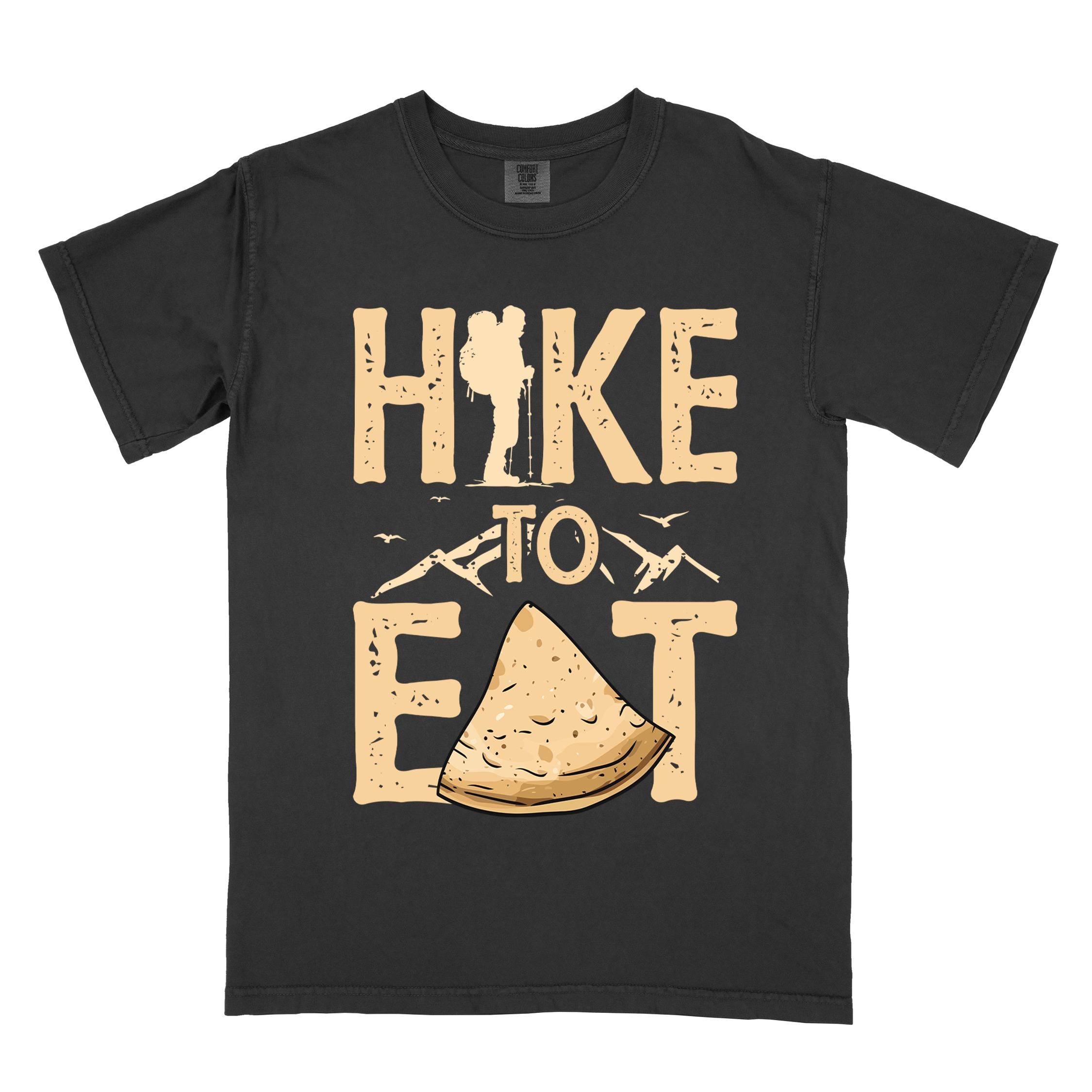 black "Hike to Eat" colored statement tee with bold typography, mountain, illustrated tortilla, perfect for tortilla lovers.