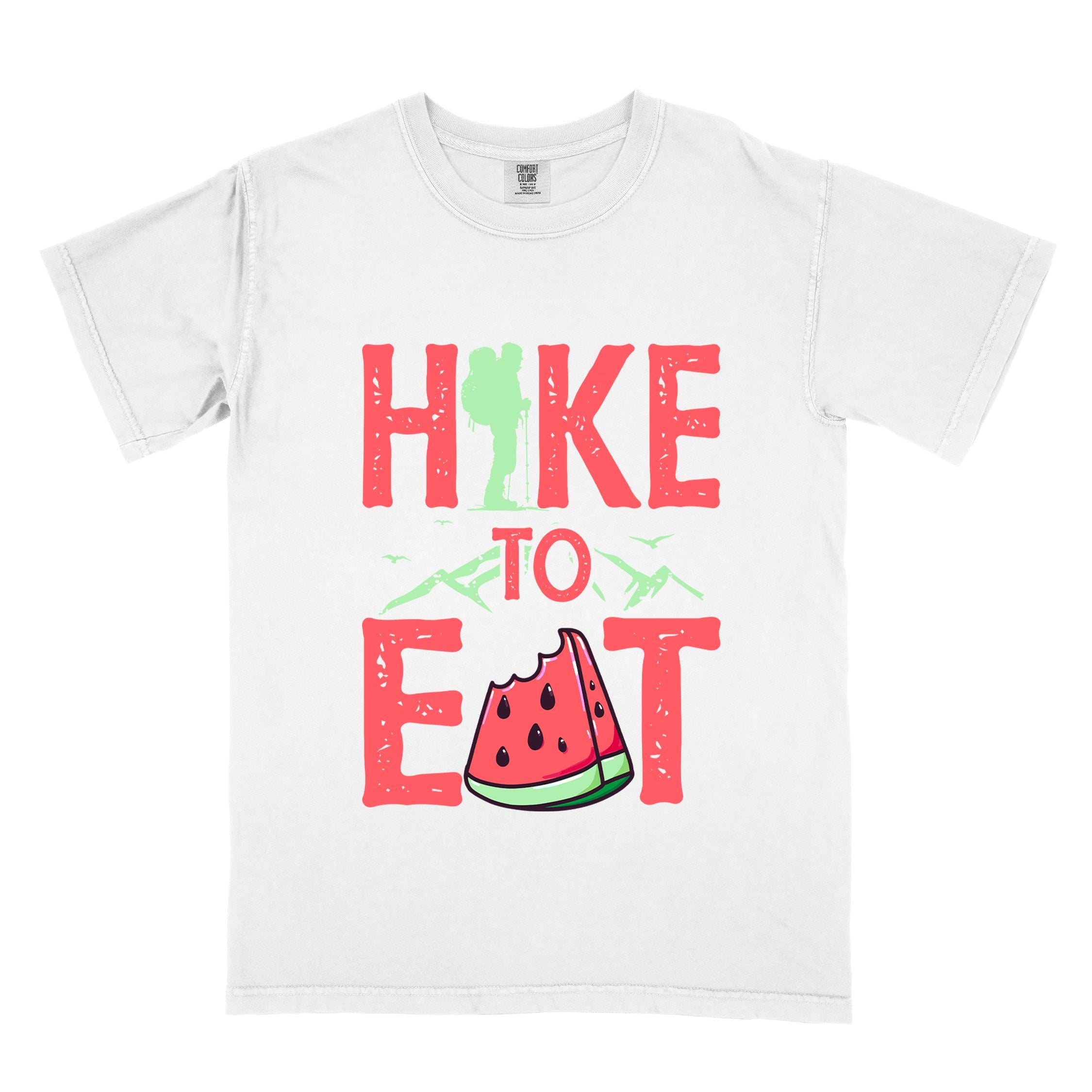 White "Hike to Eat" colored statement tee with bold typography, mountain, illustrated slice of watermelon, perfect for fruit lovers.