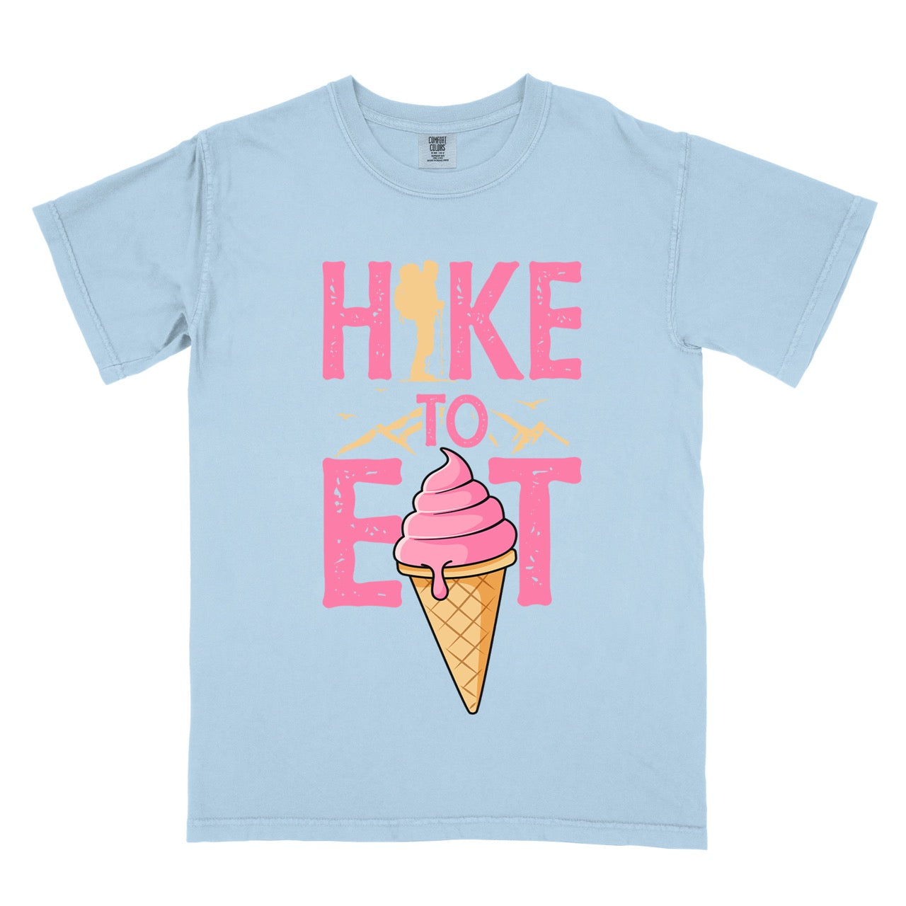 Chambray (light blue) Hike to Eat brand logo t-shirt with distressed pink typography, hiker silhouette integrated into letters, mountain peaks, flying birds, and soft-serve ice cream cone illustration for dessert-loving outdoor enthusiasts