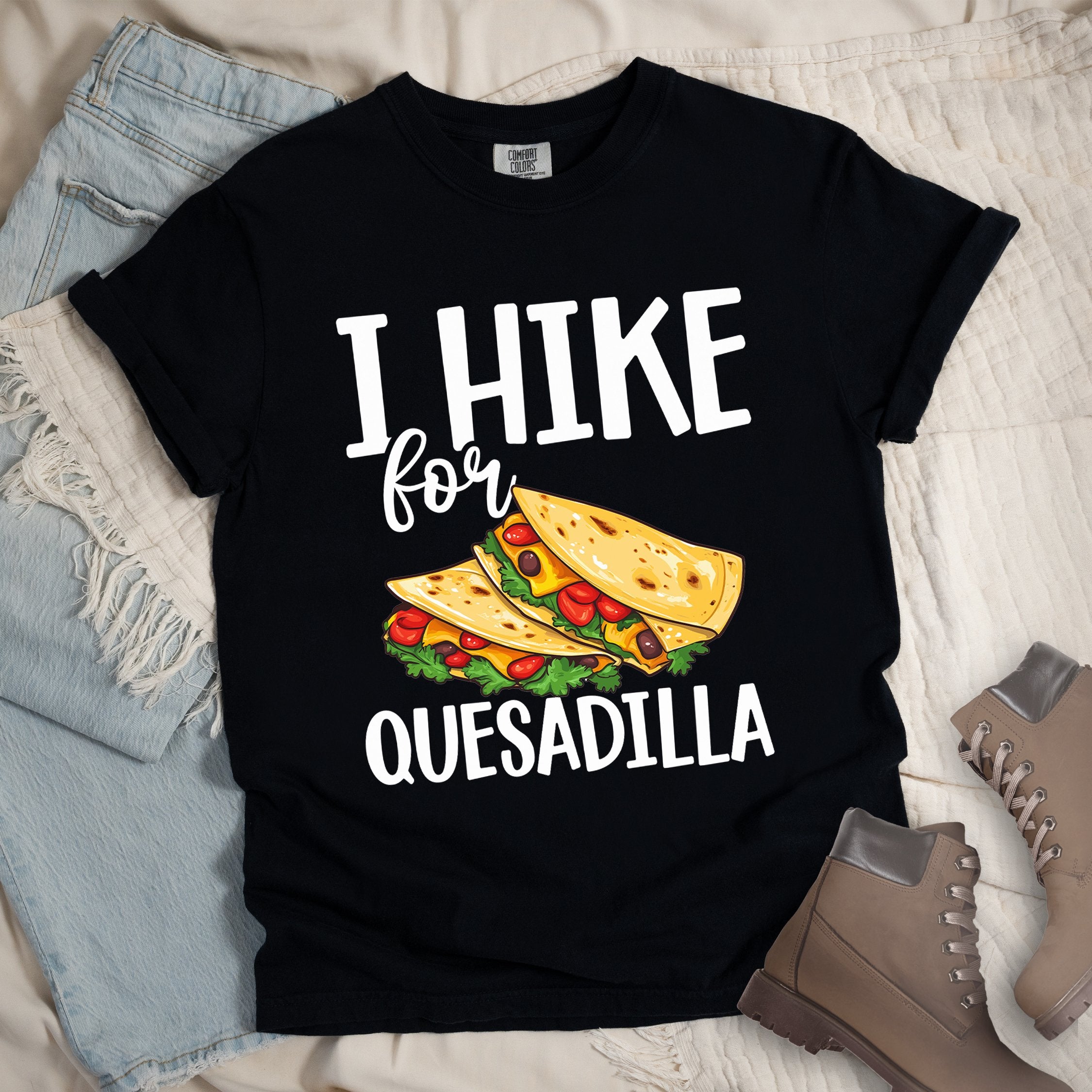 Black shirt with “I Hike for Quesadilla” text, featuring two folded quesadillas filled with cheese, tomatoes, and lettuce.