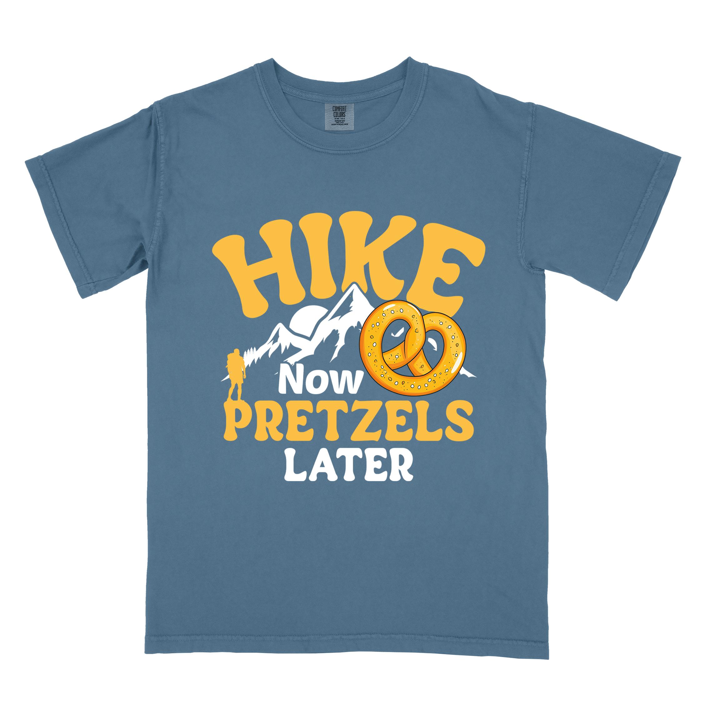 Blue jean Hike now Pretzels later colored vintage tee with bold typography, , mountains, sunrise, and illustrated pretzel for baked pretzel lovers