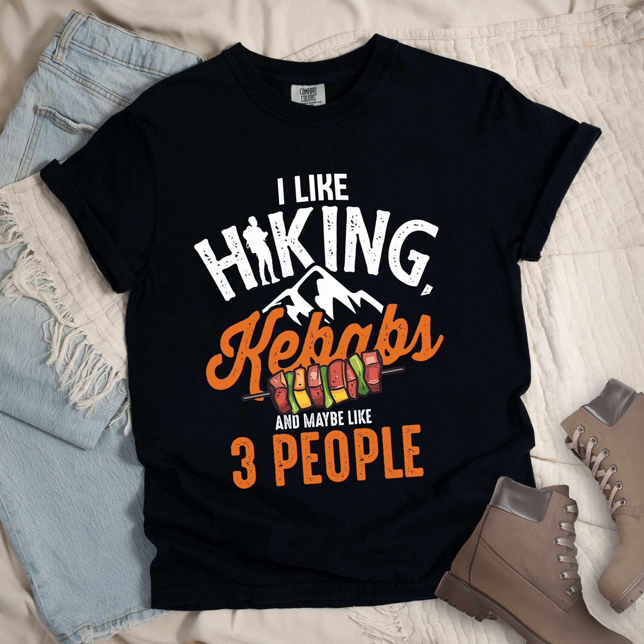 Black shirt with “I Like Hiking, Kebabs and Maybe Like 3 People” in white and orange text, featuring a hiker silhouette, mountain outline, and skewers of colorful kebabs.