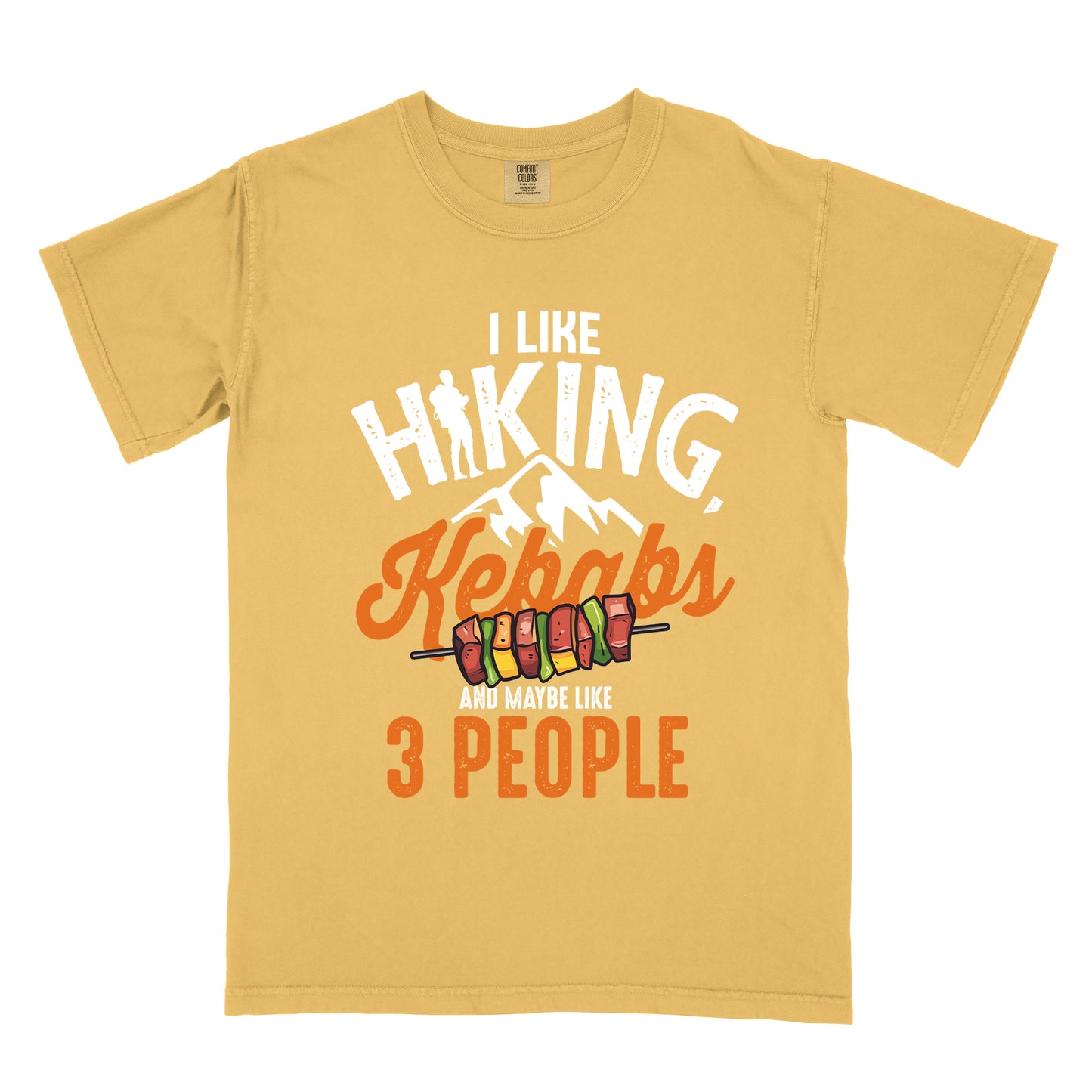 Mustard (Yellow) t-shirt with white text "I LIKE HIKING," with the letter "I" in "HIKING" replaced by a hiker silhouette. Below that is "Kebabs" in orange script with an illustration of a kebab skewer. Small white mountain silhouettes appear between these elements. At the bottom in white and orange text is "AND MAYBE LIKE 3 PEOPLE". The design combines hiking imagery with food and a humorous introvert sentiment.