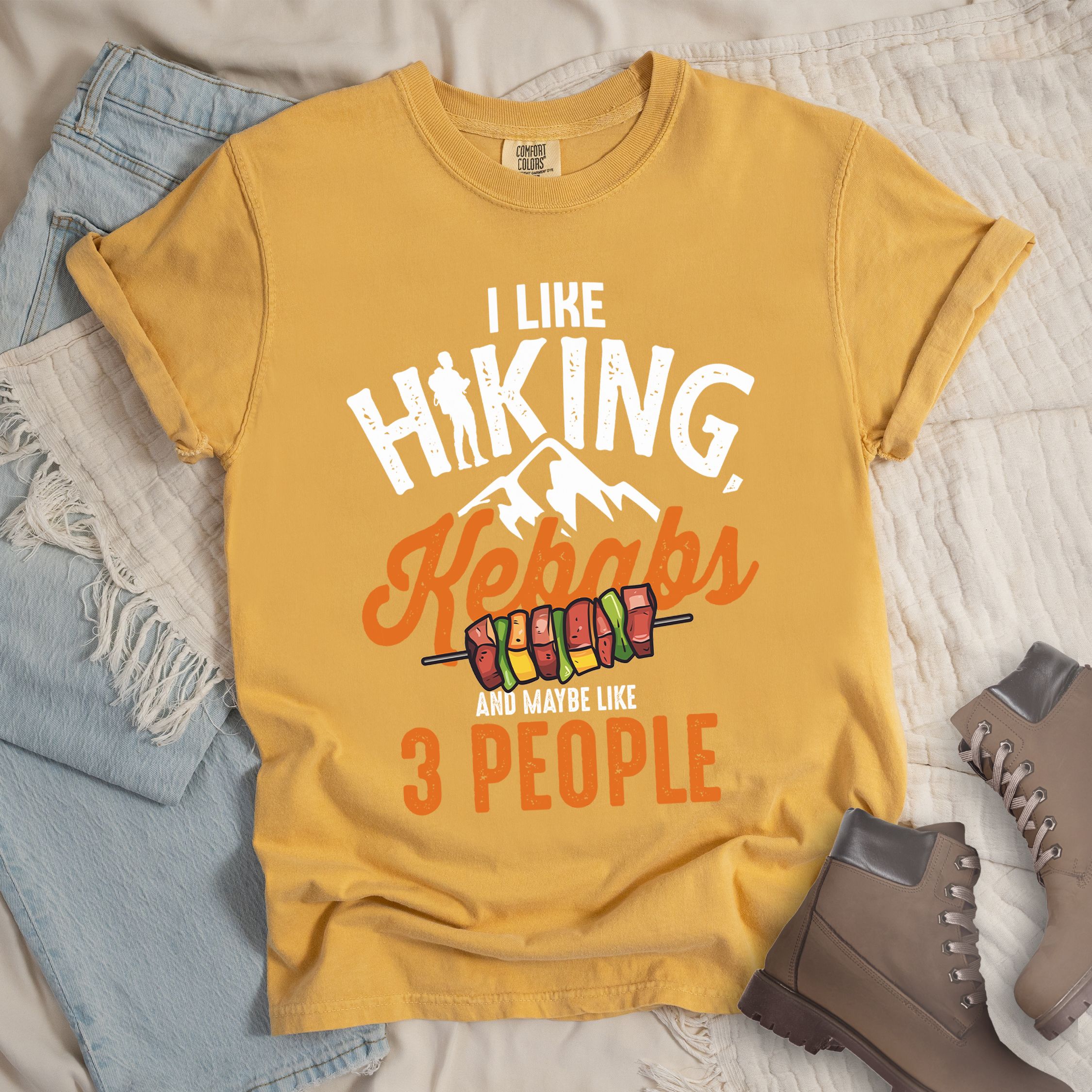 Yellow shirt with “I Like Hiking, Kebabs and Maybe Like 3 People” in white and orange text, featuring a hiker silhouette, mountain outline, and skewers of colorful kebabs.