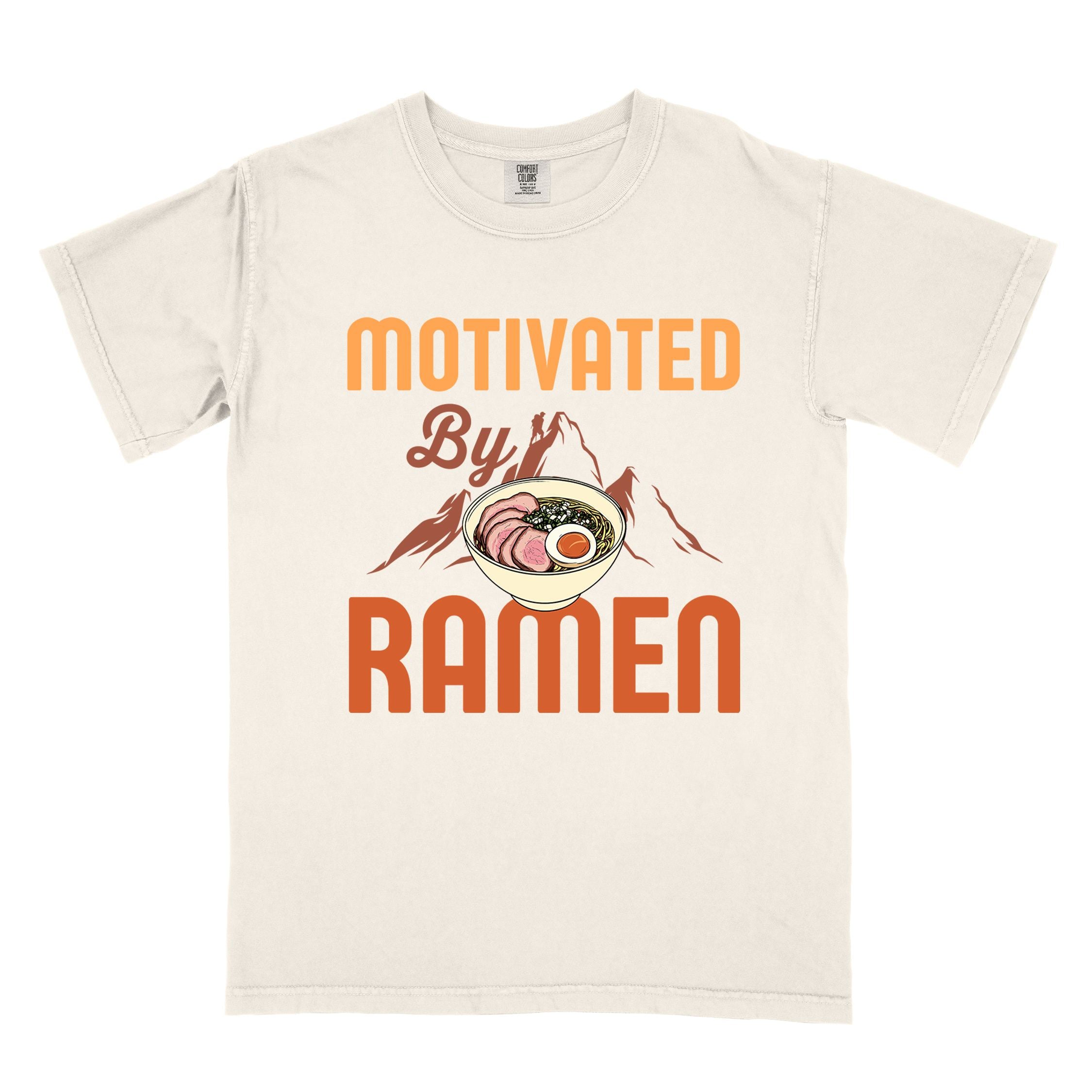 Ivory “Motivated by Ramen” colored vintage tee with bold text, mountain, Illustration of hot ramen. Perfect tee for foodie craving for a bowl of ramen,