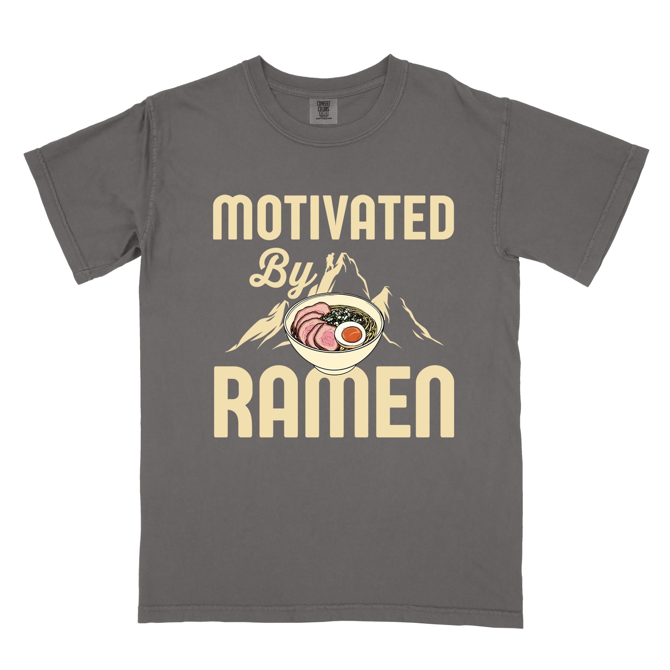 Pepper “Motivated by Ramen” colored vintage tee with bold text, mountain, Illustration of hot ramen. Perfect tee for foodie craving for a bowl of ramen,